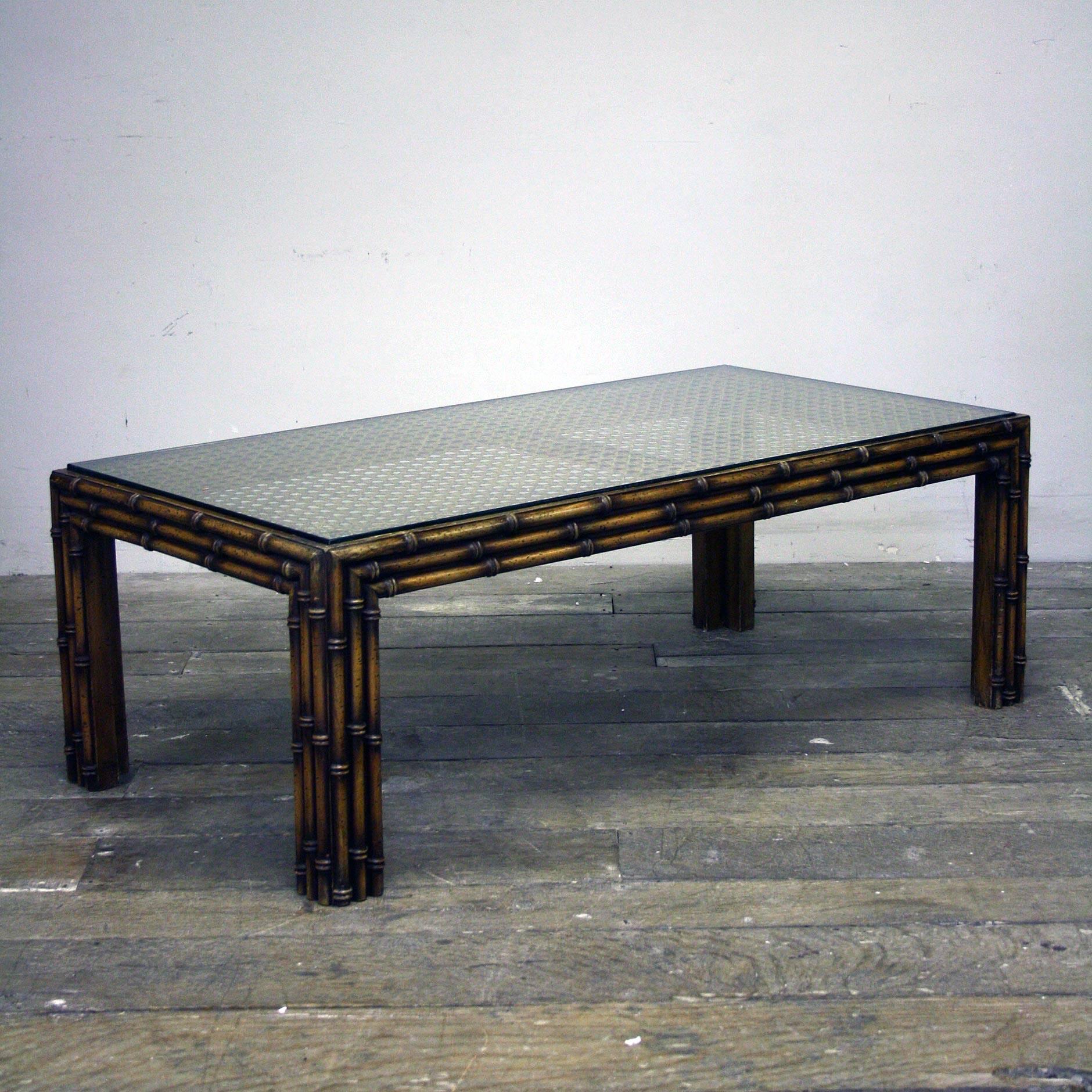 A stunning looking 1970s faux bamboo and rattan table with heavy glass top.