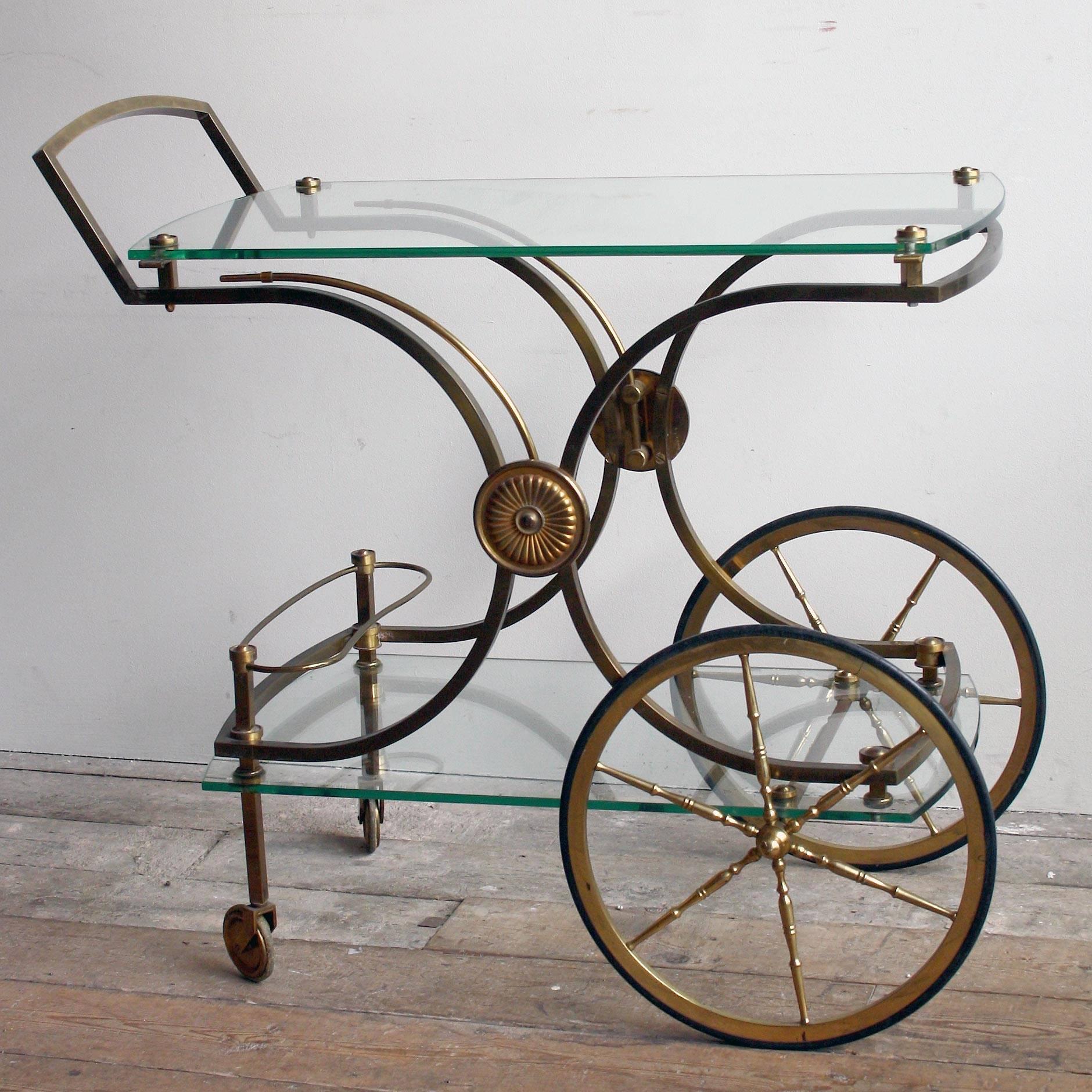 A very high quality French, 1950s brass drink trolley with glass shelves.