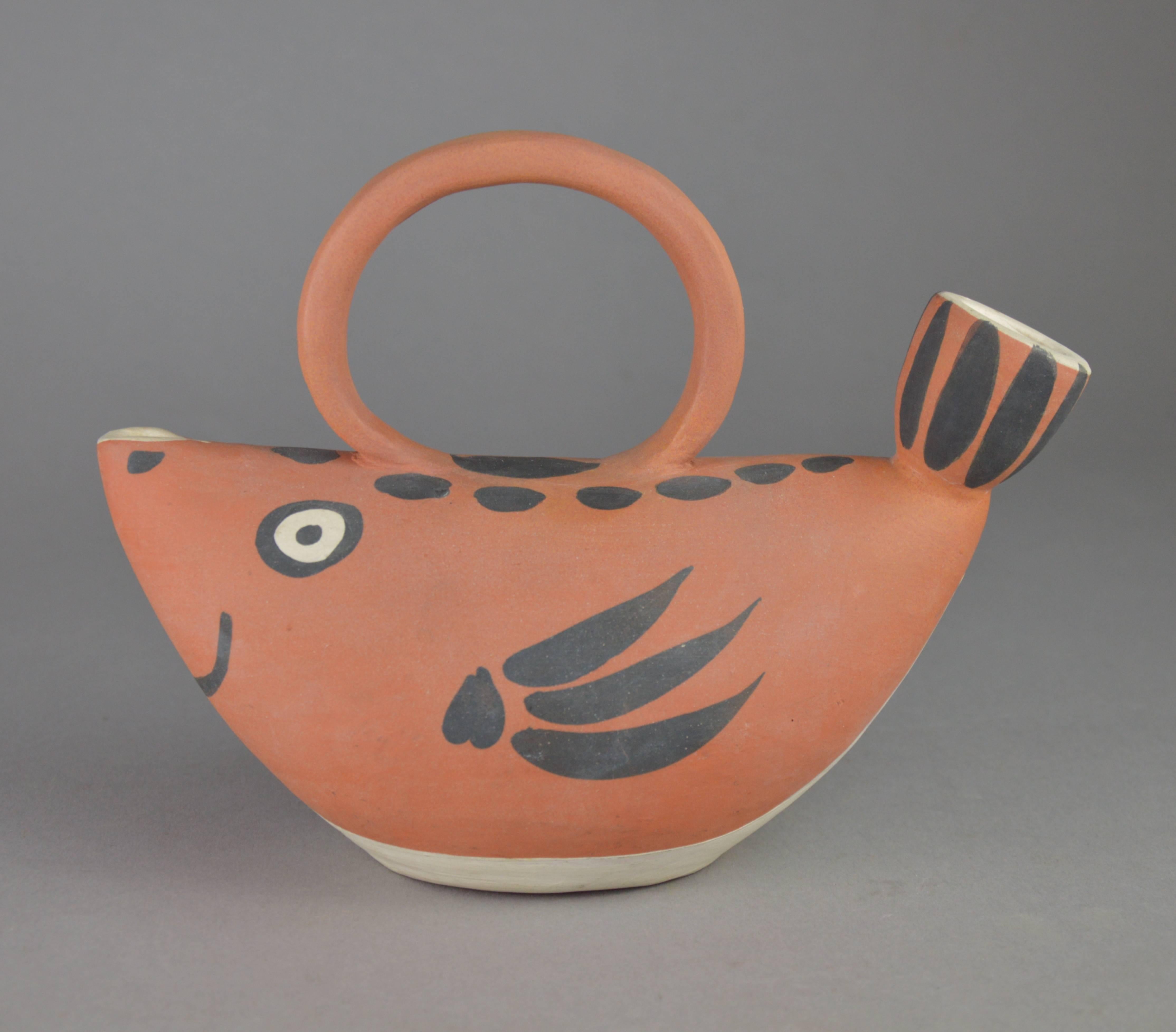 Pablo Picasso turned ceramic pitcher fish ("poisson"). Red earthenware clay, engobe decoration, Executed in an edition of 500 copies. Stamped and market 'Edition Picasso or Madoura Plein Feu'. Conceived in 1952. Literature: Alain Ramié