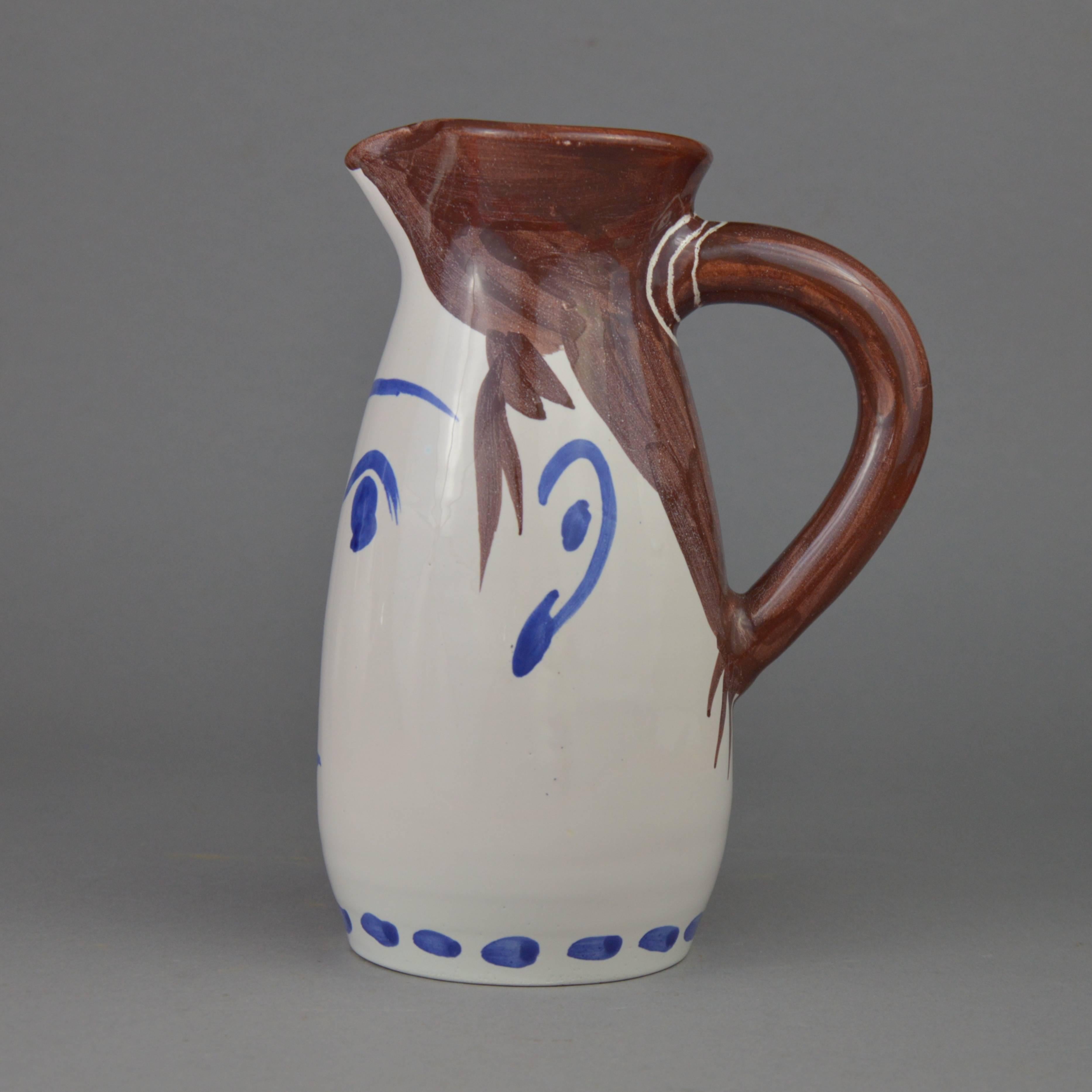 Pablo Picasso turned ceramic face tankard. White earthenware clay, oxides and white decoration. Executed in an edition of 300 copies. Stamped 'Edition Picasso Madoura/Madoura Plein Feu/Edition Picasso'. Conceived in 1959. Literature: Alain Ramié