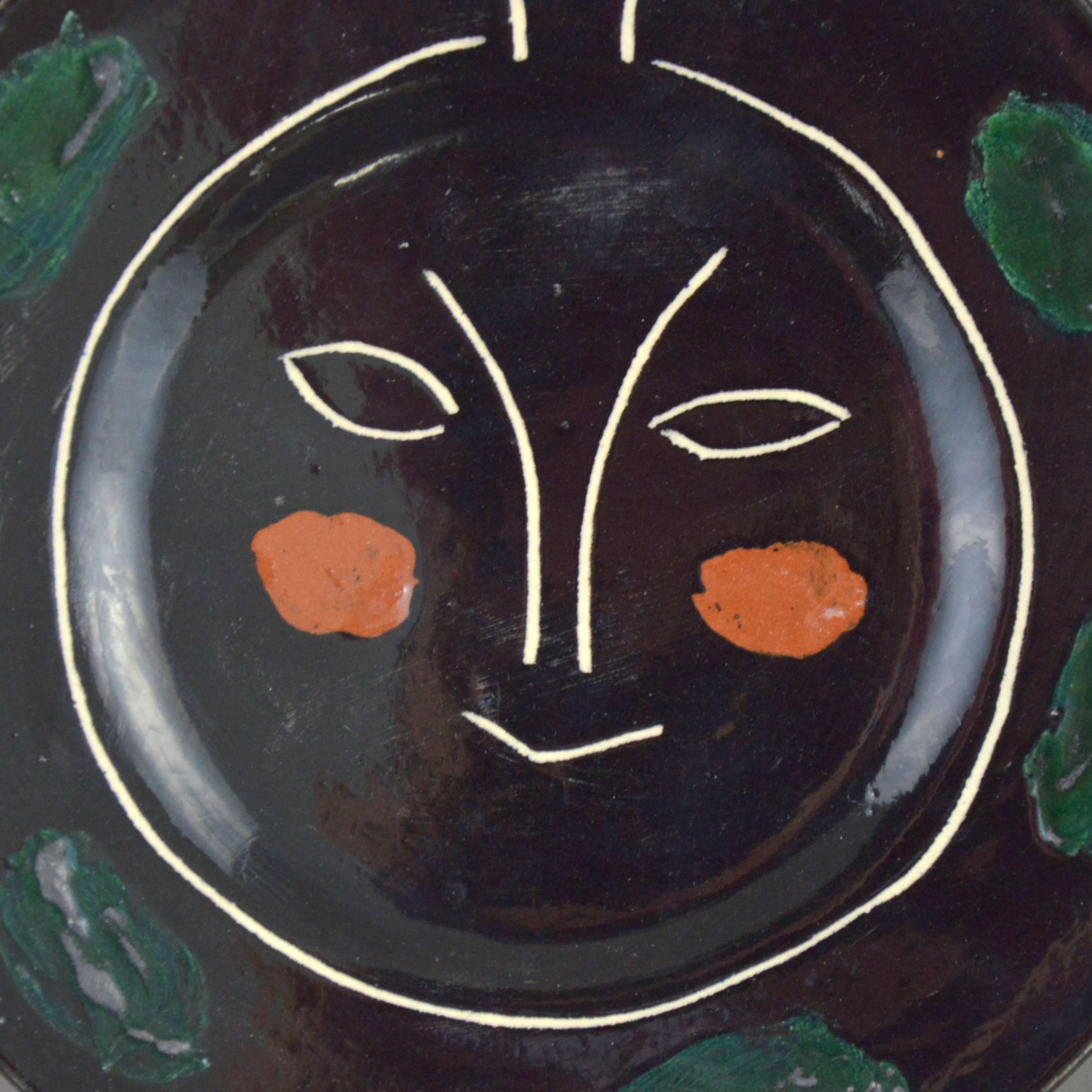 Pablo Picasso ceramic plate black face - Plate J. White earthenware clay, knife engraved underglaze and engobes decoration. Executed in an edition of 100 copies. Stamped and marked 'R/Madoura Plein Feu/D'Apres Picasso'. Conceived in 1948.