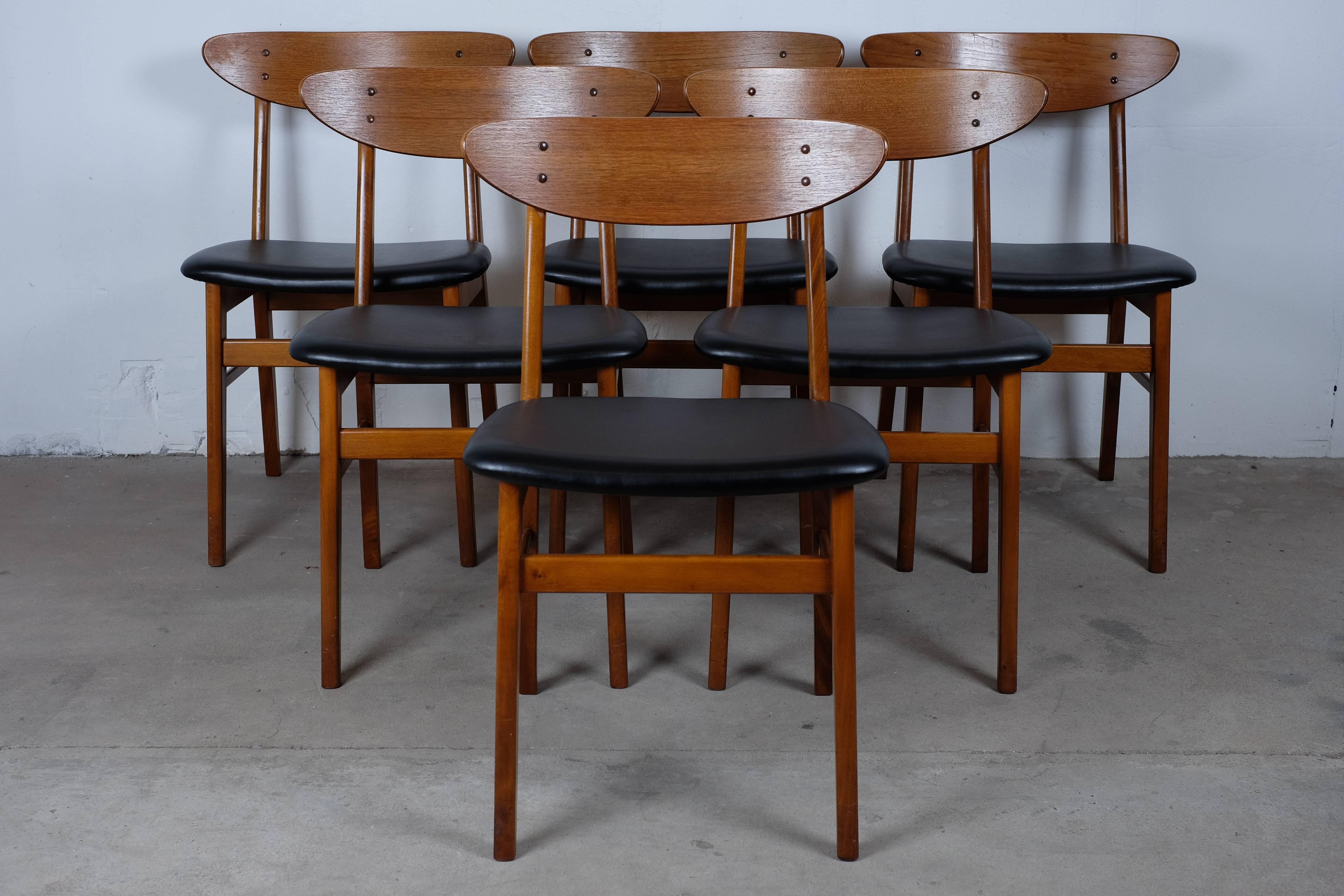 This beautiful set of six dining chairs was manufactured by Farstrup Møbler in the 1960s. 

These chairs feature a teak backrest on a beech frame and are upholstered with real black leather in great quality. 

The chairs are in great condition!
