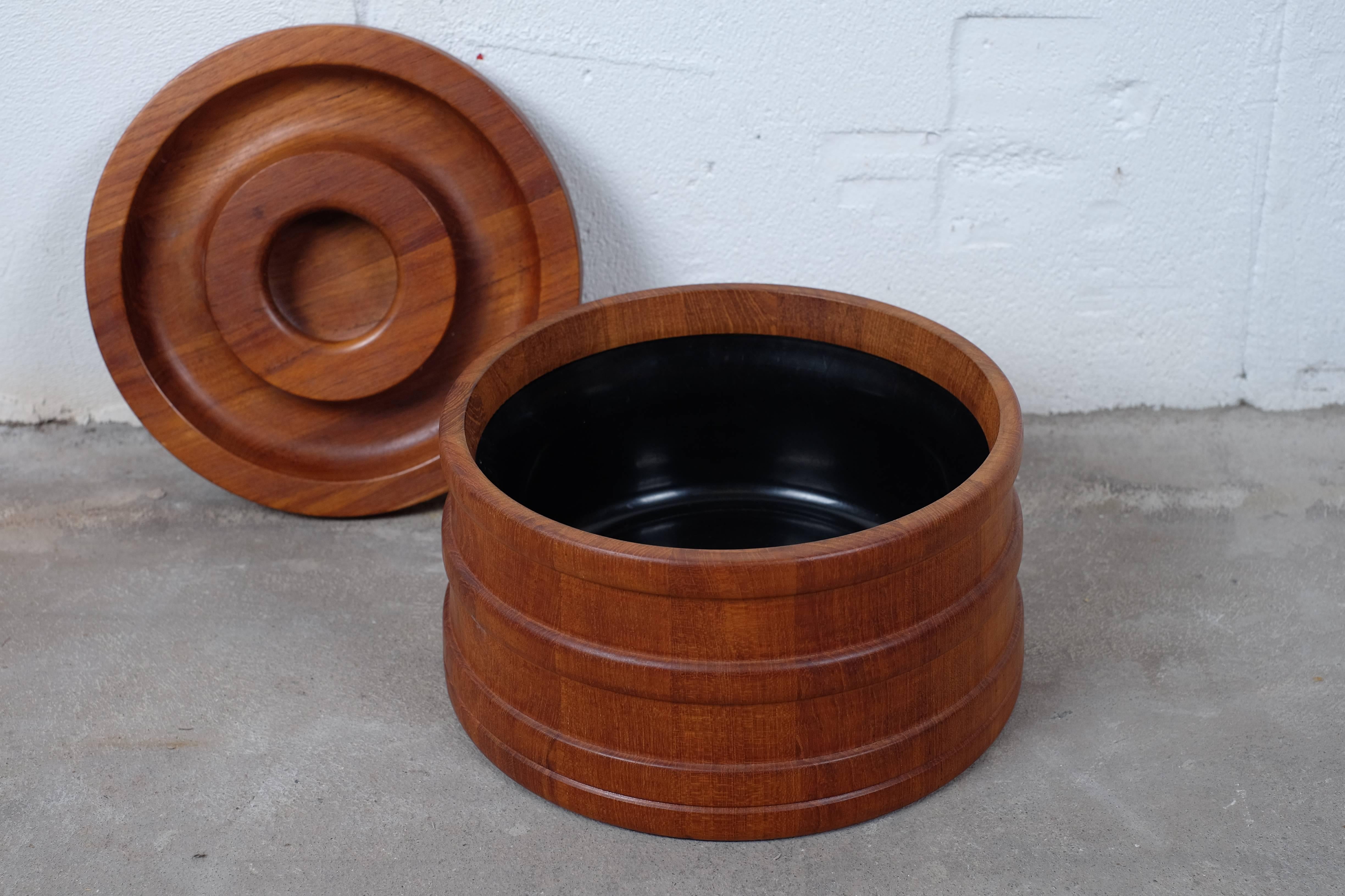Danish design ice bucket in teak by Jens Harald Quistgaard. 

The container is a slightly tapered cylinder banded with rings in teak. 
Retains its original black plastic liner inside.

Branded mark on underside, Dansk design.

Condition is