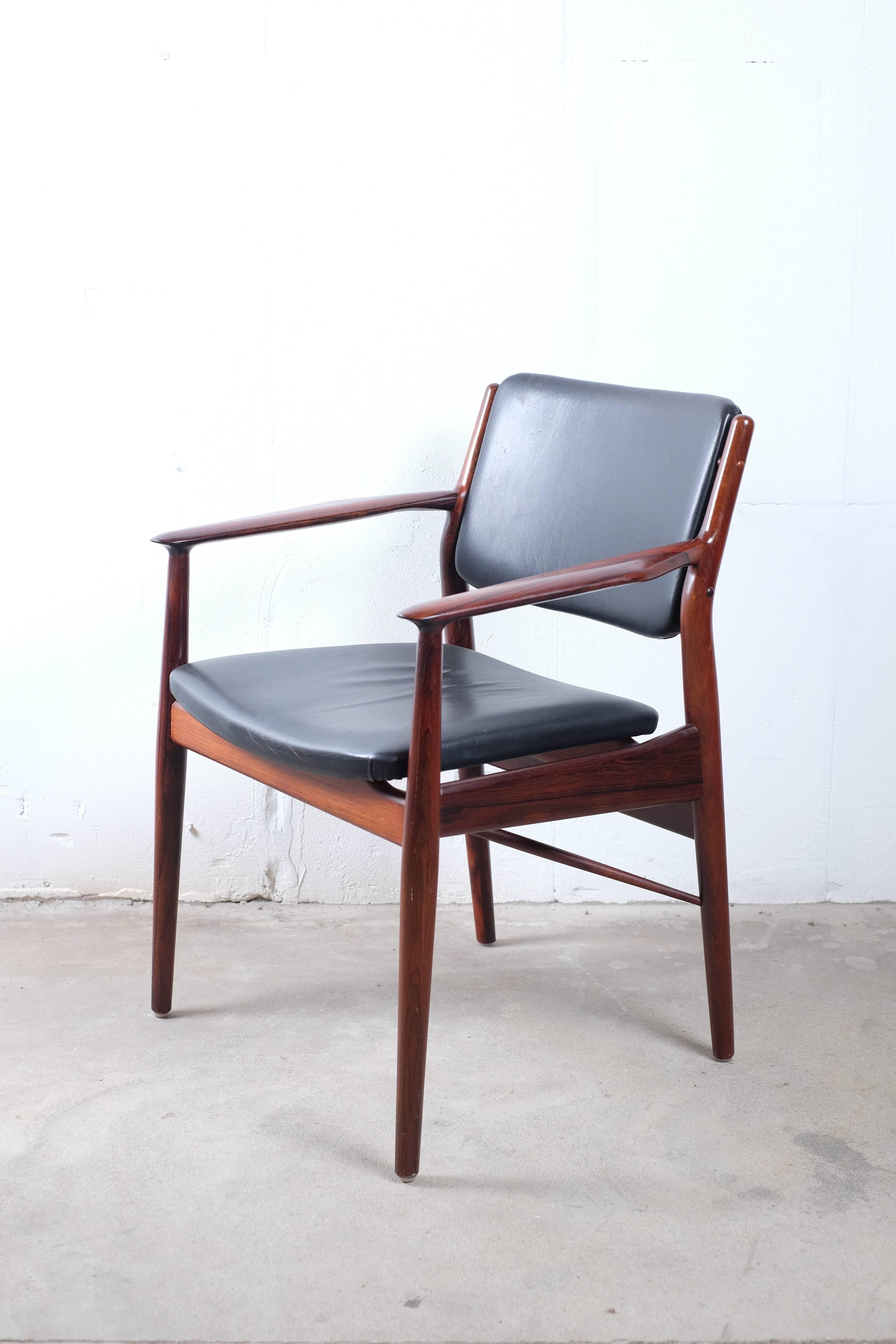 This amazing armchair is made of solid rosewood with black leather on seat and back. Very good seating comfort and is suitable as a desk chair or for the table end. 

The chair has a great expression that exudes quality and design. Small signs of