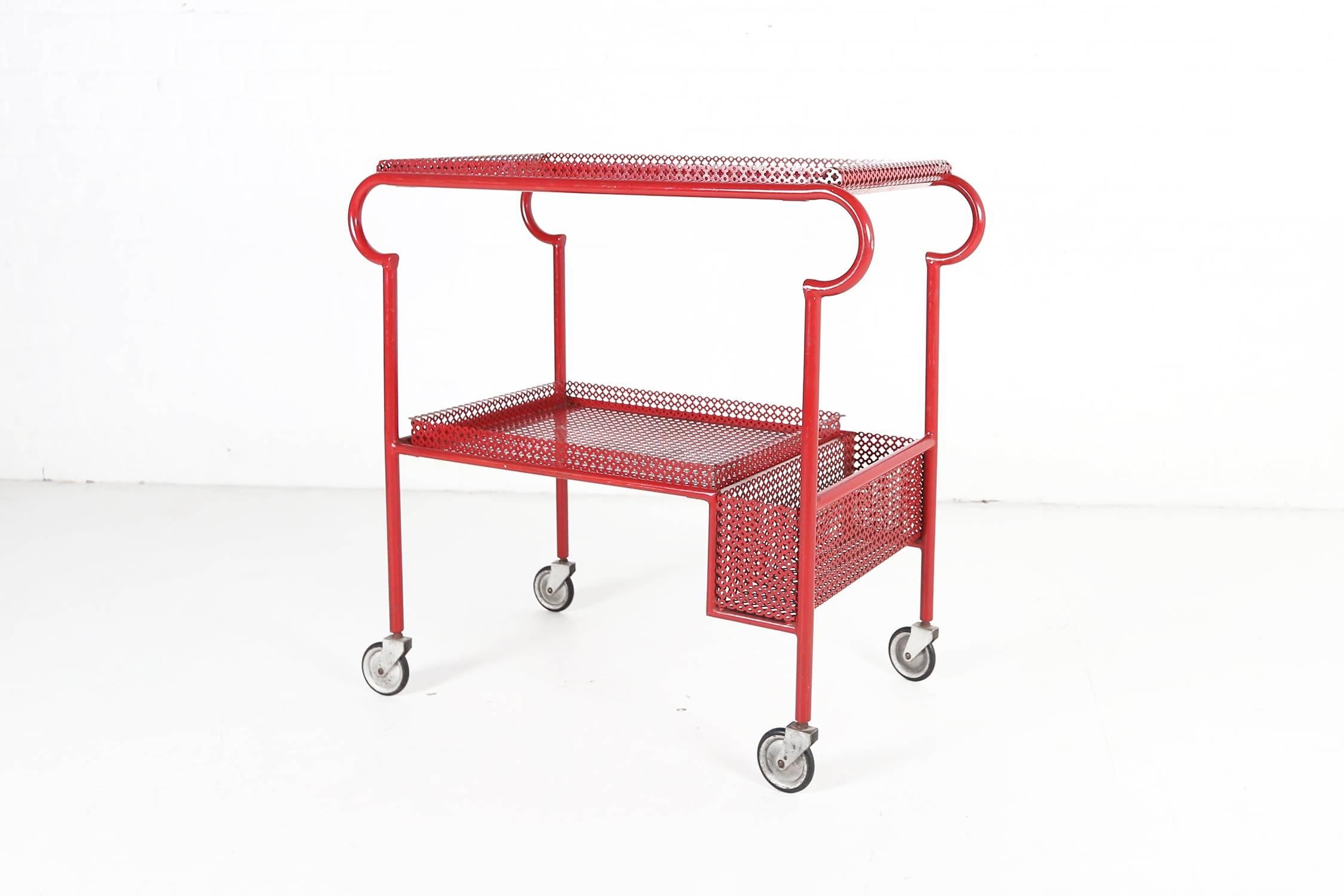 Exceptional French drinks trolley with removable perforated painted metal serving trays and bottle holder. Detailed rolled metalwork, circa 1950.
All in the original red paint.