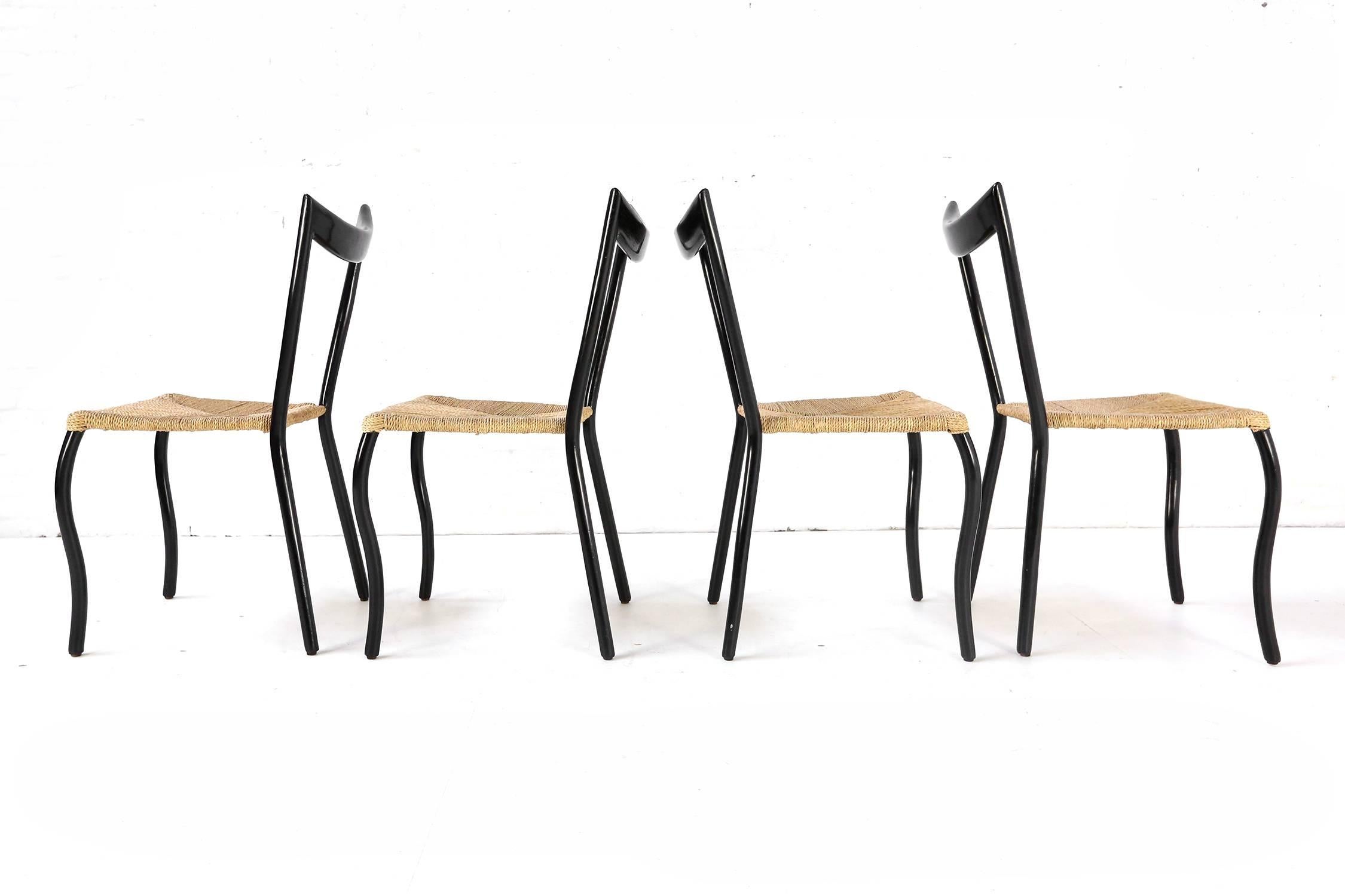 A striking set of ebonized bentwood dining chairs in the distinct style and manner of Gio Ponti. Attention to detail and smart design are obviously hallmarks of these beautifully made chairs. Rush is in good condition throughout. Chairs are tight
