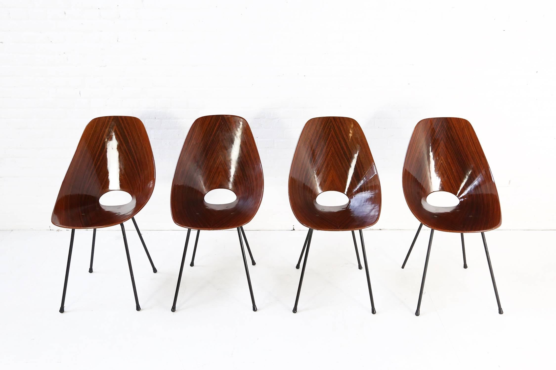 A rare set of six Medea chairs in rosewood designed by Vittorio Nobili in 1950 and manufactured by Fratelli Tagliabue, Italy. A beautiful set of chairs and awarded the Industrial Design award Compasso d'Oro. 
Molded plywood seats with black steel