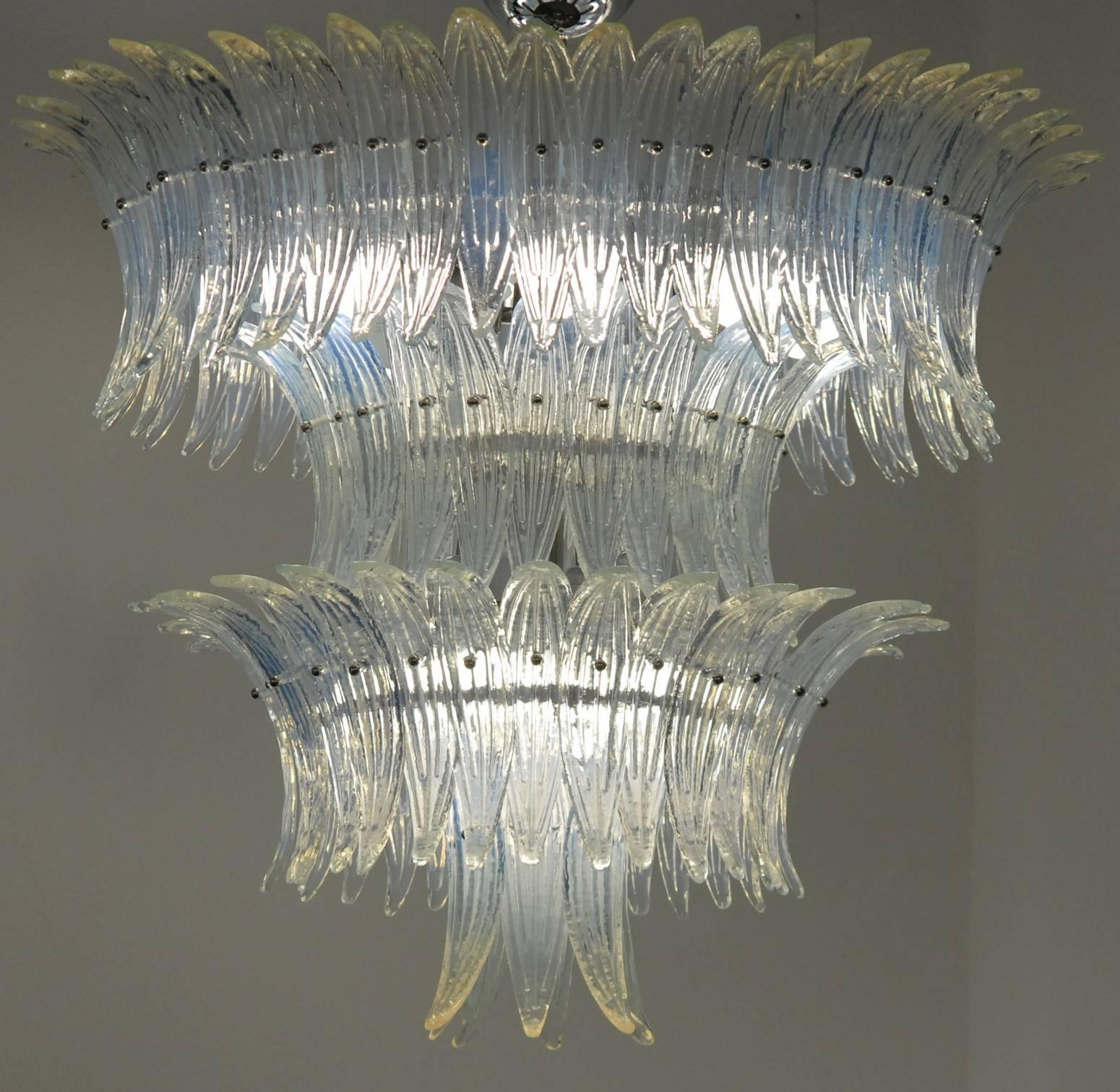Large and imposing Mid-Century chandelier. For modern and eclectic homes and halls. Would also be stunning in public places. 

The opaline bluish tone enhances the design. There are more than 100 elements of palm (palmette) leaves. Piastra