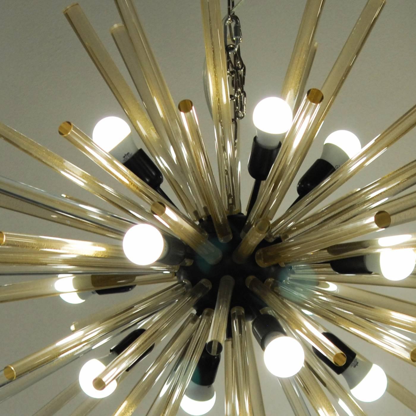 Luxurious and magnificent Mid-Century style sputnik chandelier. Murano glass hand-pulled rods embedded with pure gold leaf made at Alberto Donà’s factory. Imposing chandelier. Black hardware with gold leaf hand pulled glass rods. The quintessential