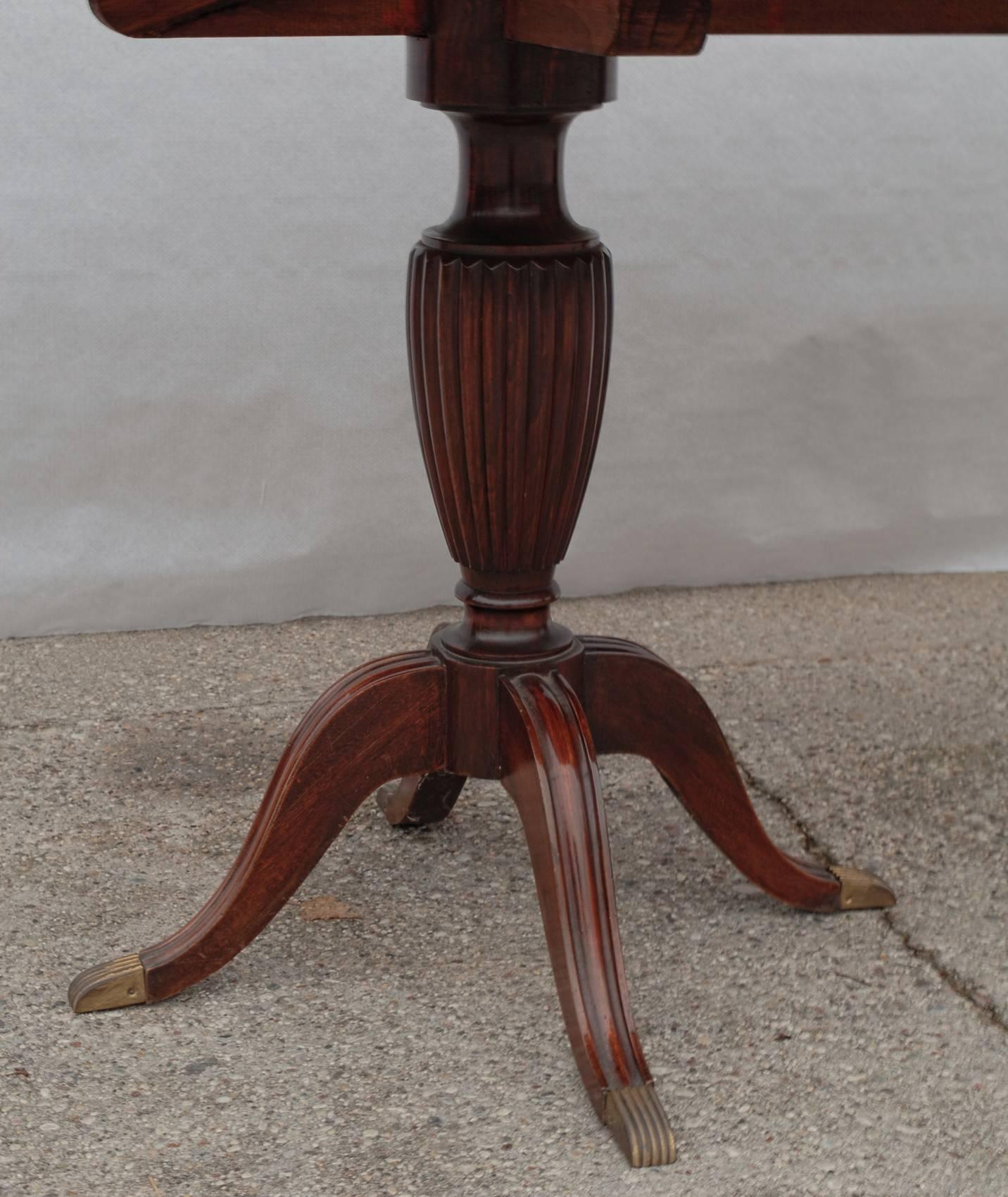 It's a Regency style table, either pre owned or made in Cantù area in the 1950s. I am not expert of the period and it came in just becuse the owner of the chairs did not want to sell the chairs separately.

The two pillars have fluted carvings and