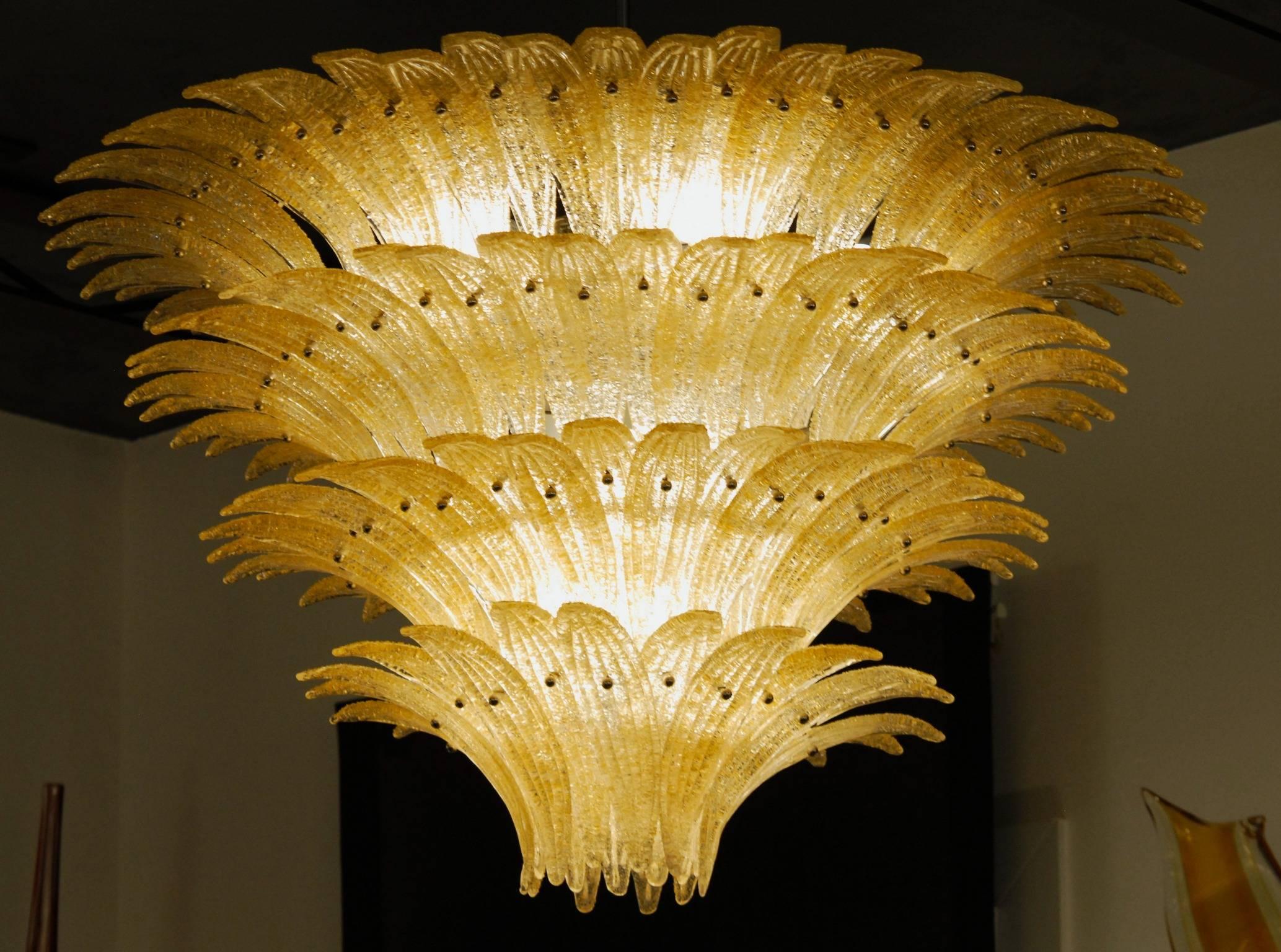 Monumental Midcentury Modern chandelier. For classic and eclectic homes and halls.

Would also be stunning in public places. The gold tone achieved with the amber application enriches an already beautiful design. The palm leaves are dense and cover