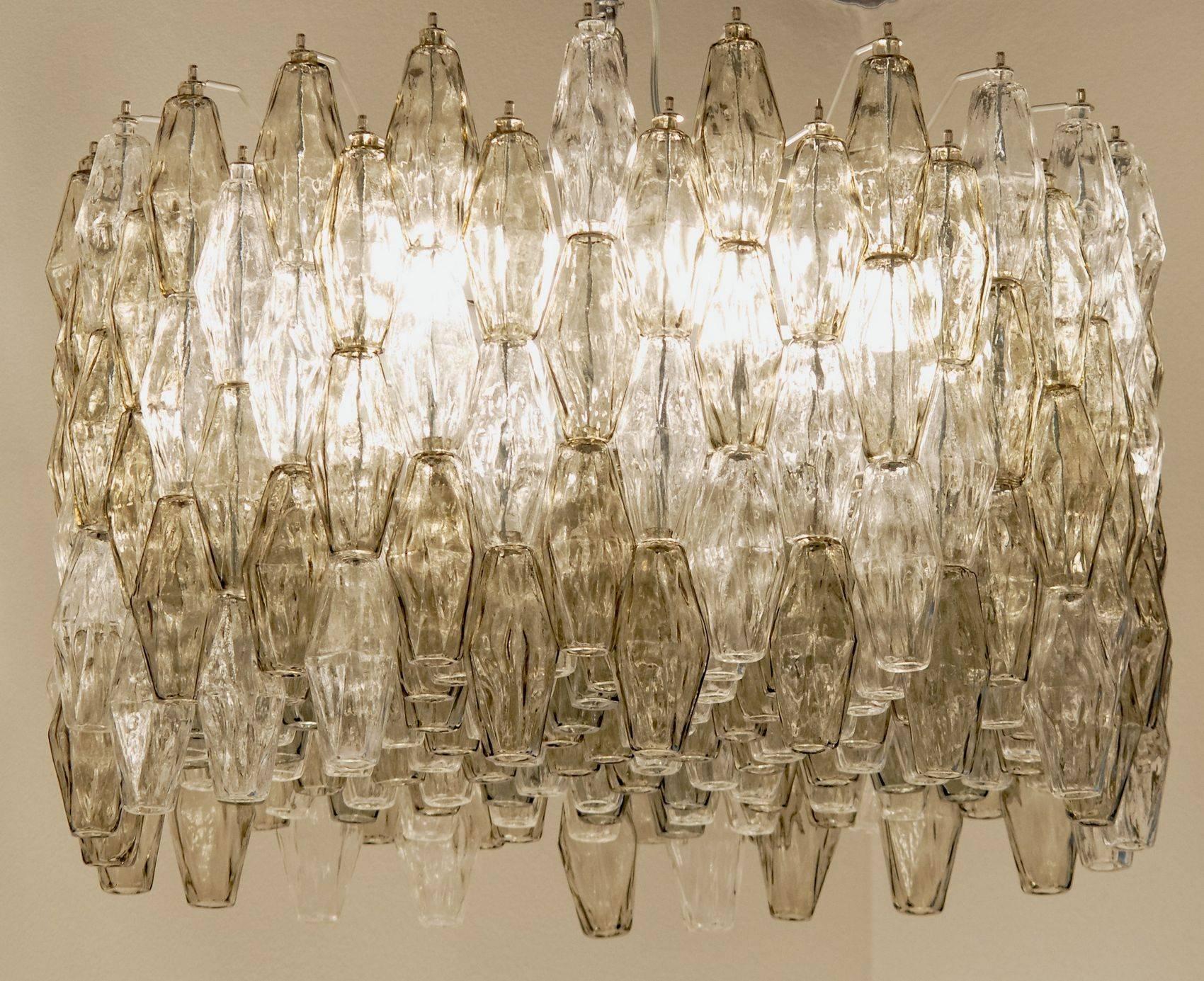 Magnificent iconic Mid-Century chandelier. For modern and eclectic homes. Would also be stunning in public places. The gray and clear color combination fits the color trends for home furnishing.

Poliedri or polyhedral chandelier. Very interesting