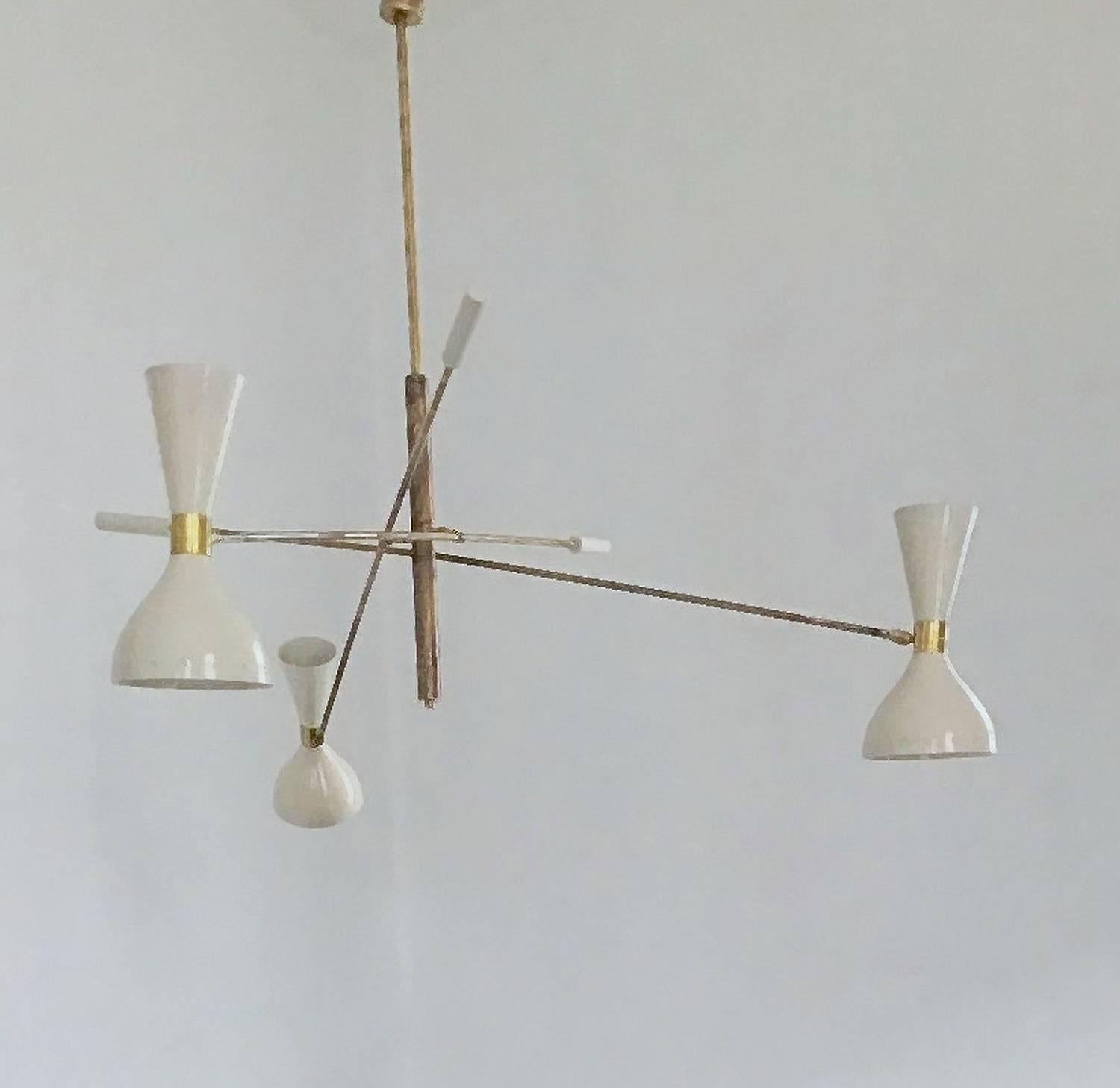 A wonderful interpretation of the Mid-Century iconic three-arm chandelier. Made by a lab specialized in Mid-Century restoration. Owner is a collector himself and connoisseur of the period. This chandelier takes it's inspiration from the triennale