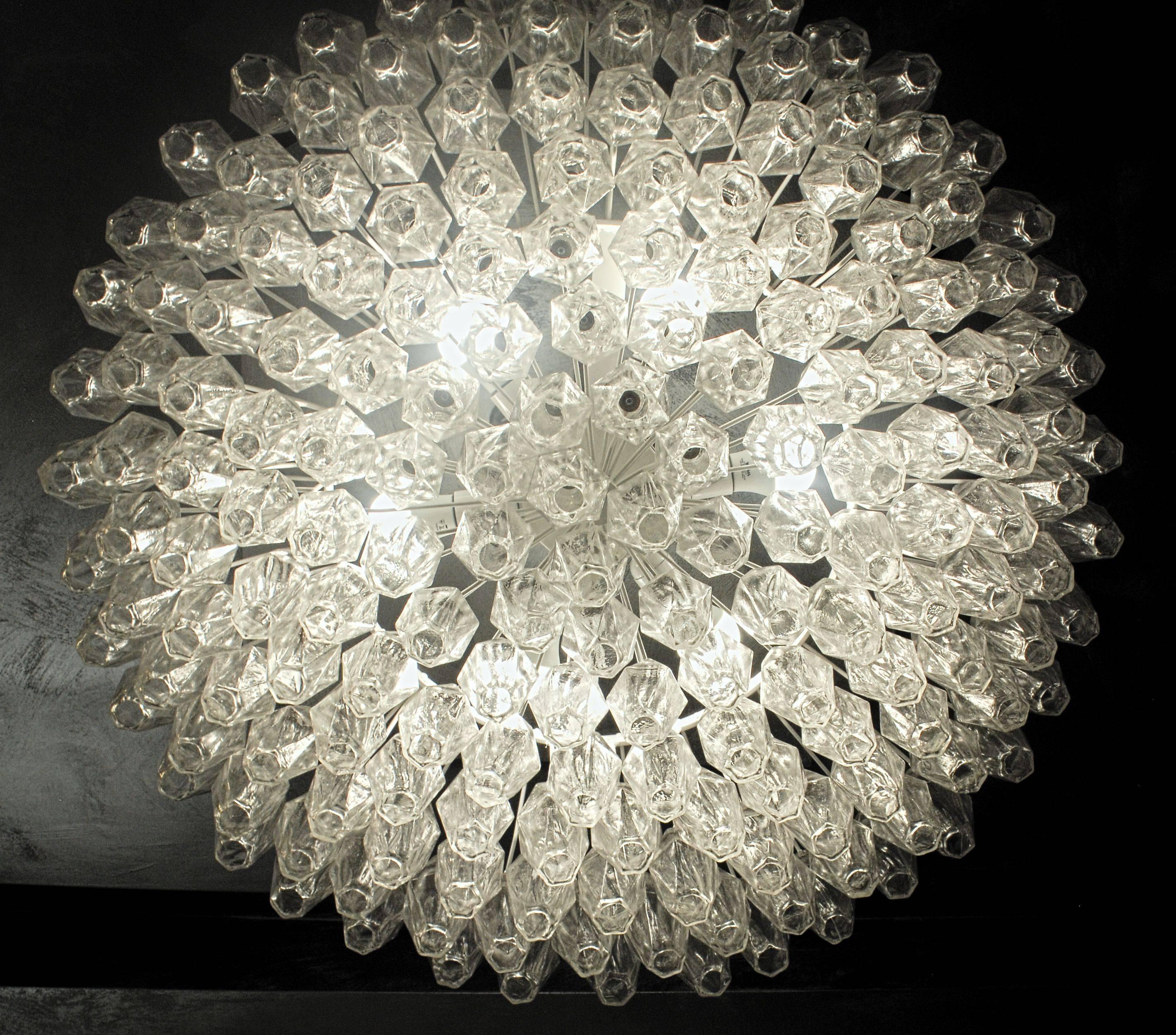 A large version of the poliedri chandelier. Iconic midcentury. This triedri chandelier is in clear crystal glass. 

Best for large a large hall, ballroom or a public space. Would be stunning in a large midcentury living room or an eclectic home.