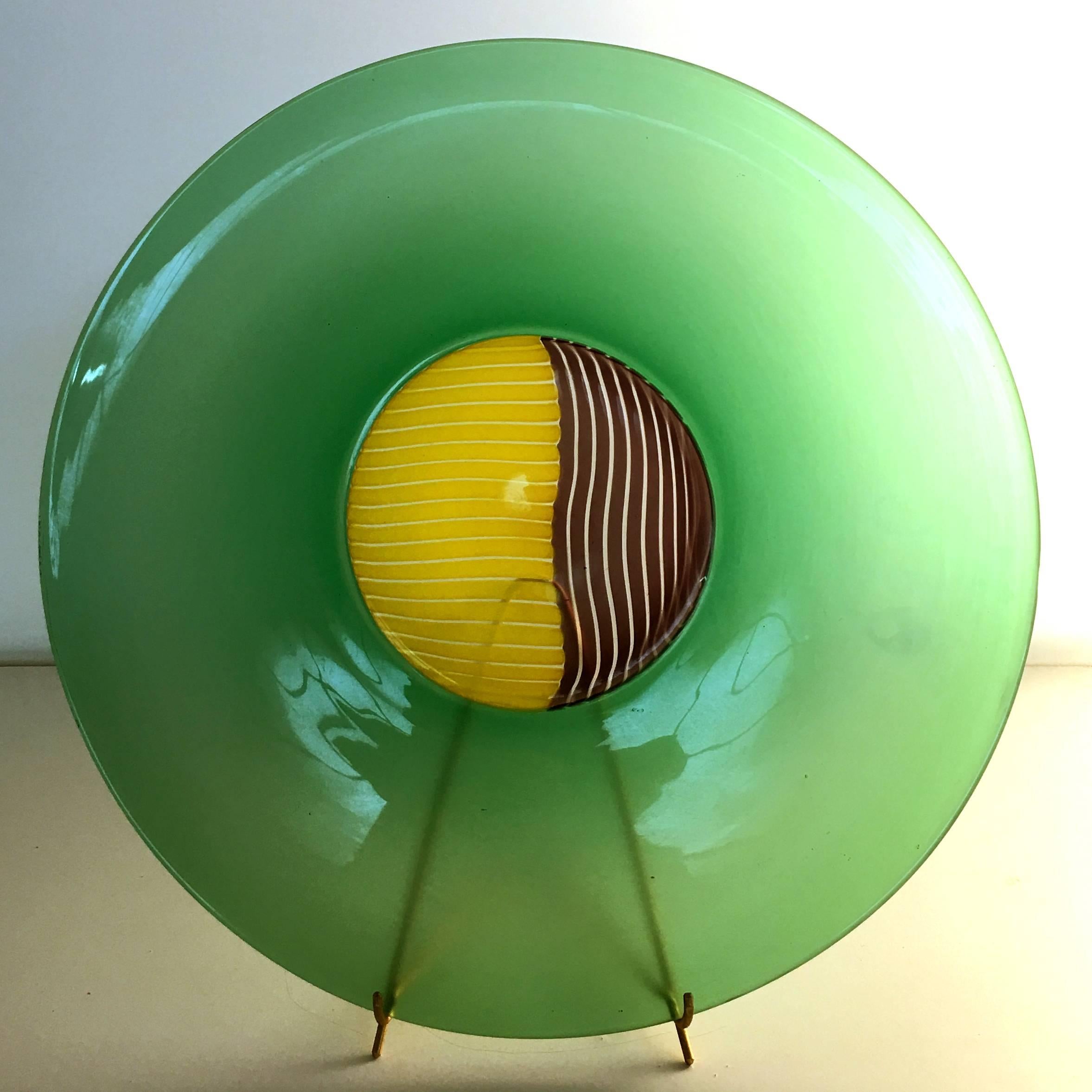 Attributed to Lino Tagliapietra: charger with stand, 1990s production from Effetre. Green incalmo with piera cane central design. Beautiful and rare.

Charger/plate, hand opened with central part made up of two-tone piera canes and incalmo lip in