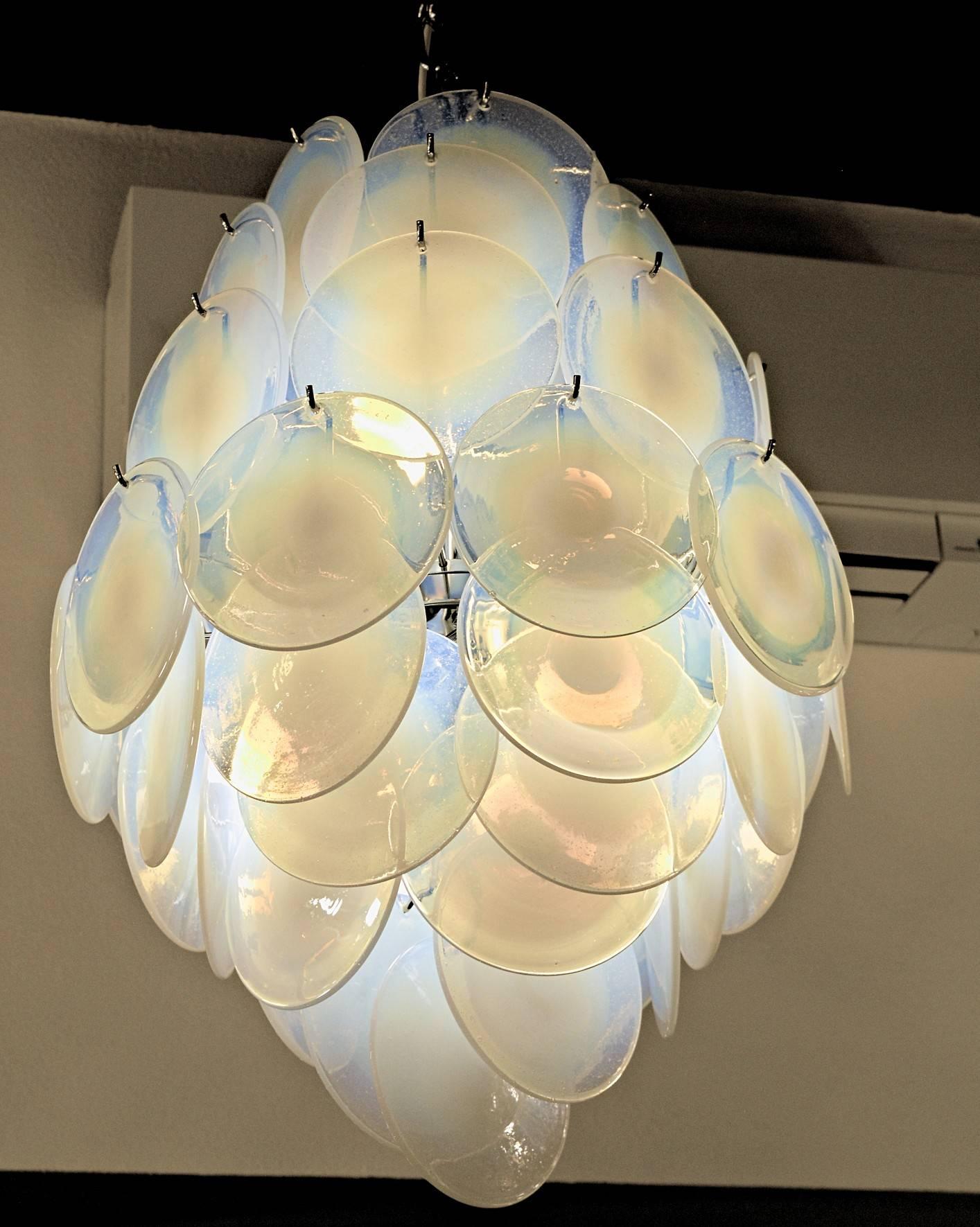 This beautiful chandelier carries 58 discs made with the rullati technique. The same technique was used to make Renaissance windows. Opaline color, a difficult color now not possible to produce, hand opened and flattened. Chrome hardware.

Carlo