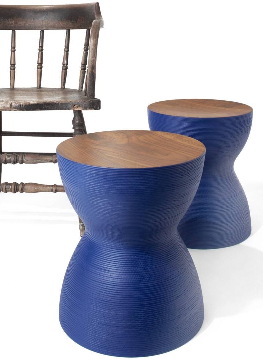 Stacked lamination of ash hardwood with a walnut of birch top, turned on a lathe. This pleasing sculptural object can be used as a side table or stool for seating. They look great in colors, blue, red, or black. They are made of solid wood and have