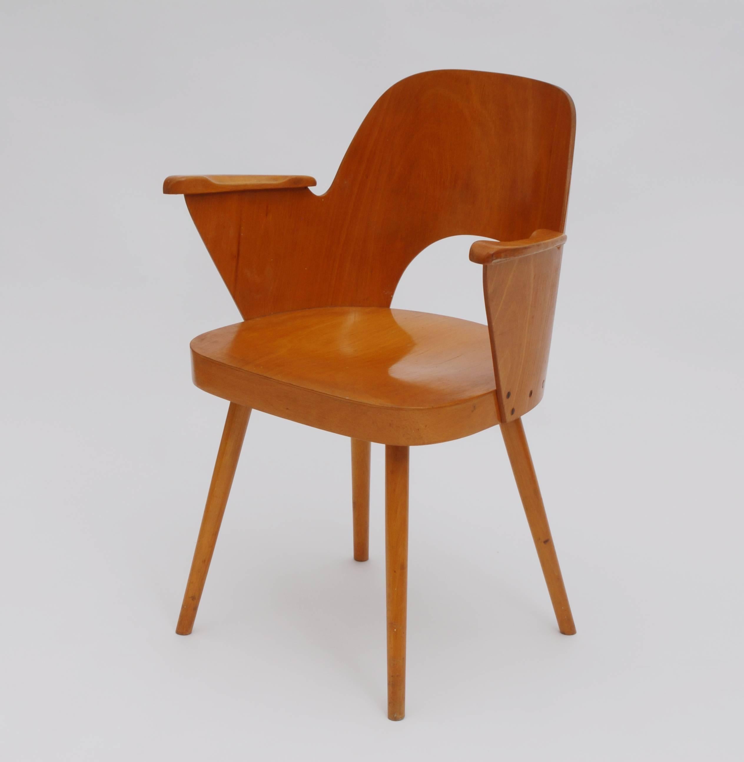 This wooden armchair with armrests was made in Czechoslovakia, circa 1960 by TON. Narodni podnik Bystrice pod Hostynem.
   