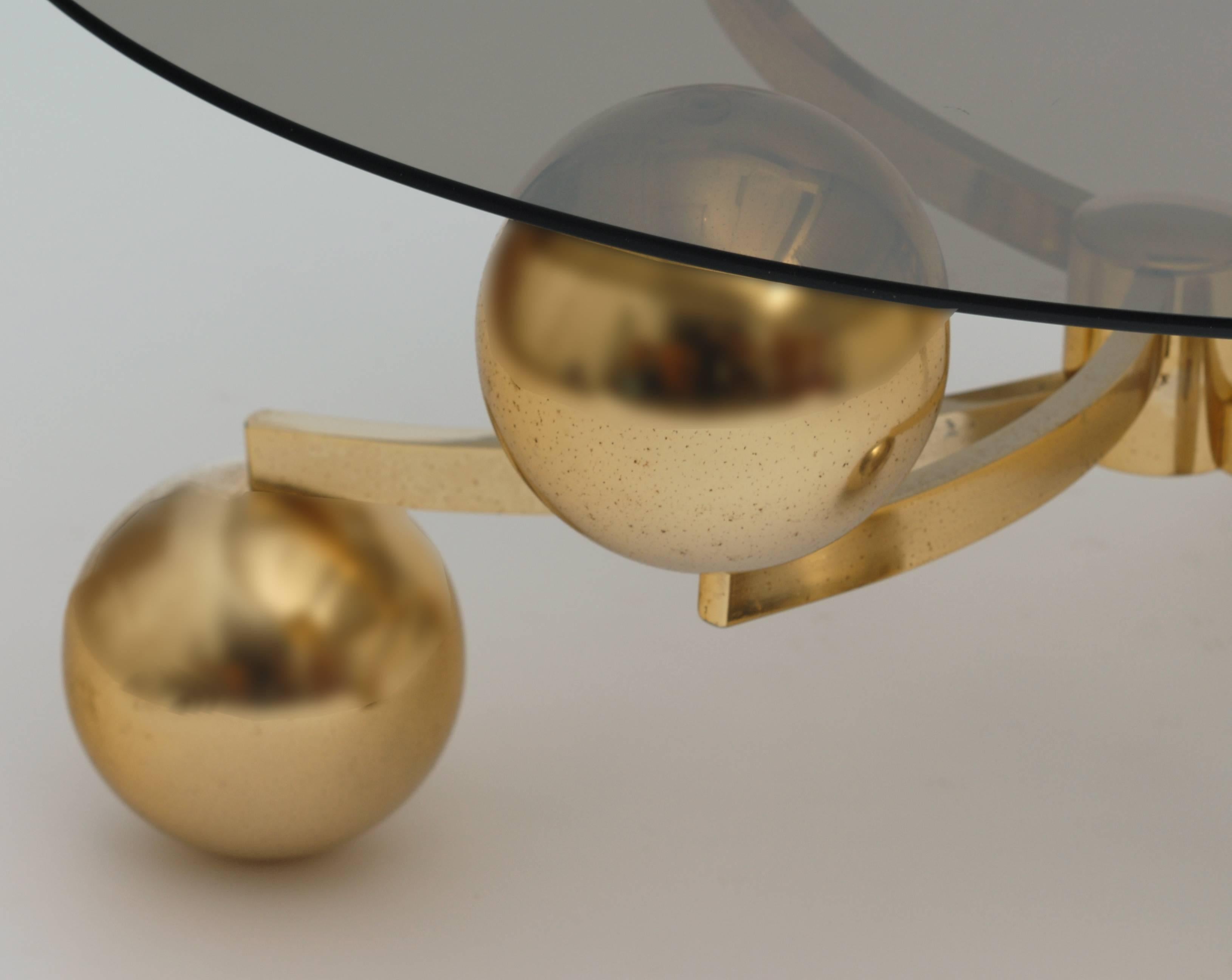 Brass coffee table Sputnik with smoked glass, the glass and the table are in perfect condition.