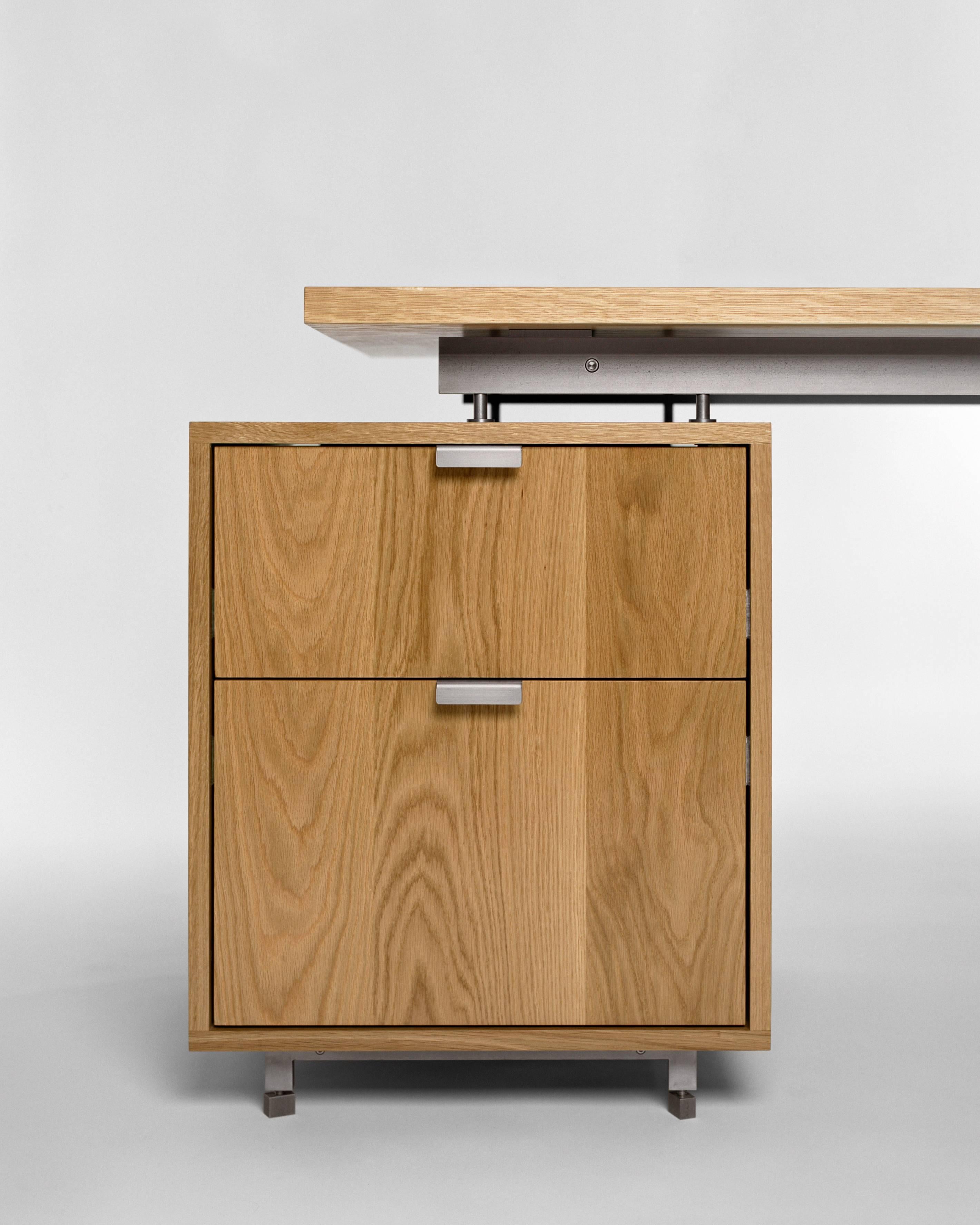 Elegant, comfortable and confident. The AD6 is handcrafted of dovetail-joined solid hardwood and cold-rolled steel bar; a study in the basic elements of composition: line, plane and volume. Includes one file and one storage drawer. 

Shown in solid