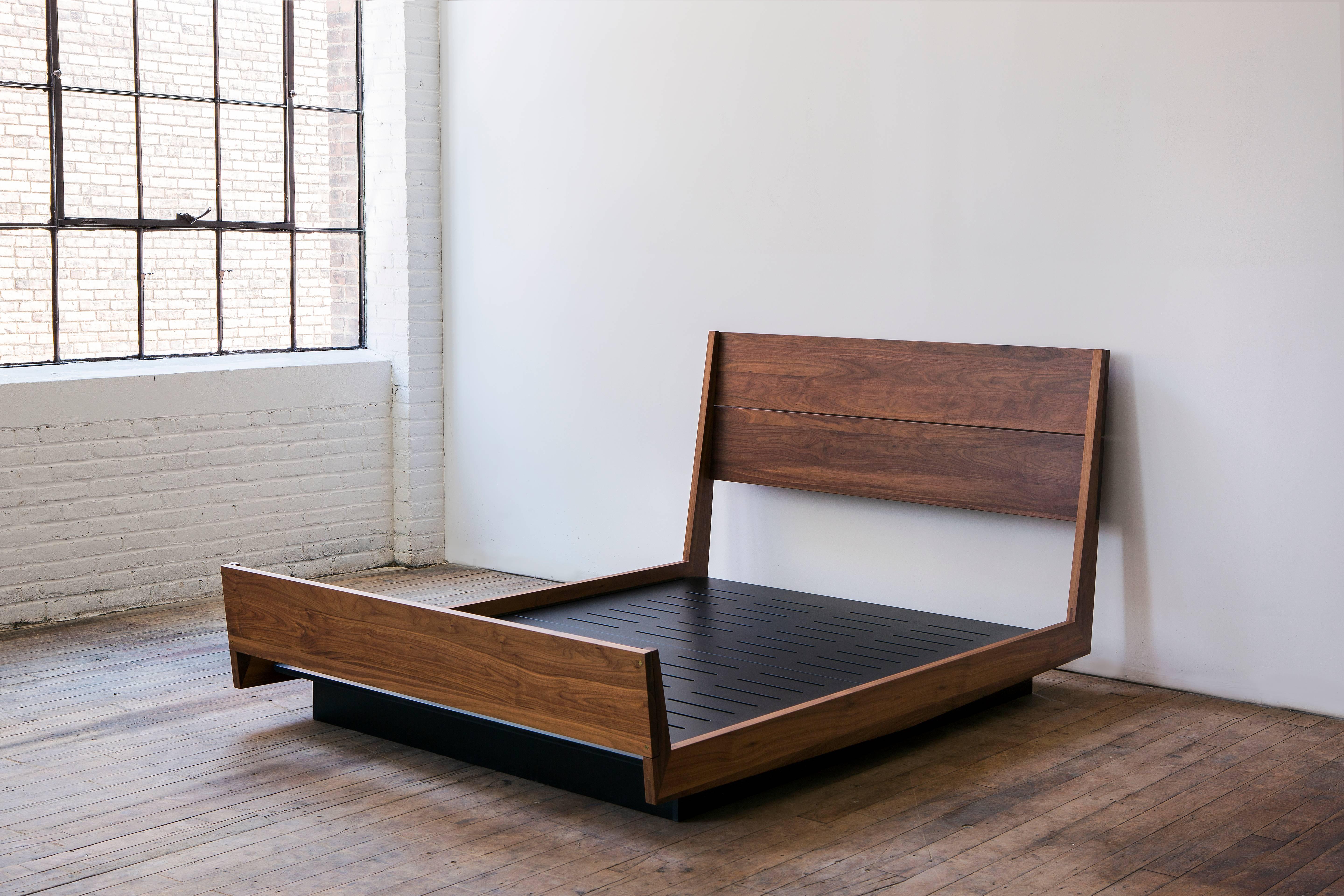 A contemporary, handmade, floating platform bed with headboard and footboard. Solid hardwood bed frame and black opaque lacquered mdf platform base. 

Shown in solid walnut with black opaque lacquered mdf base. 

Dimensions: 63.5” W x 40” H x 88.5”