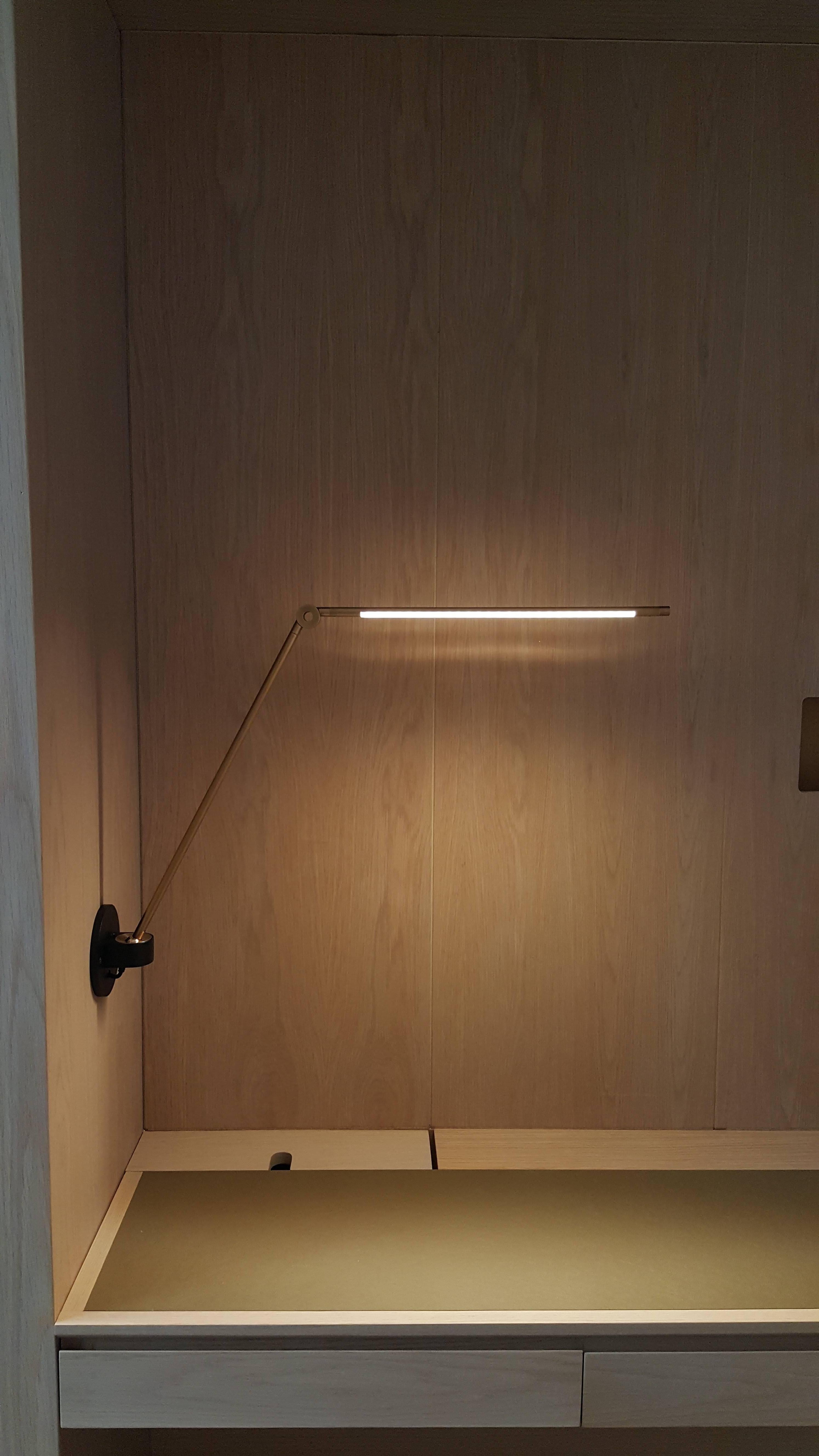 The lamp’s slender arms stretch across a work surface without taking it over and the mounted ball joint and spring-less hinge enable 360 degree movement, while also allowing the lamp to reduce into a minimal vertical profile. Elegant dimmer knob at