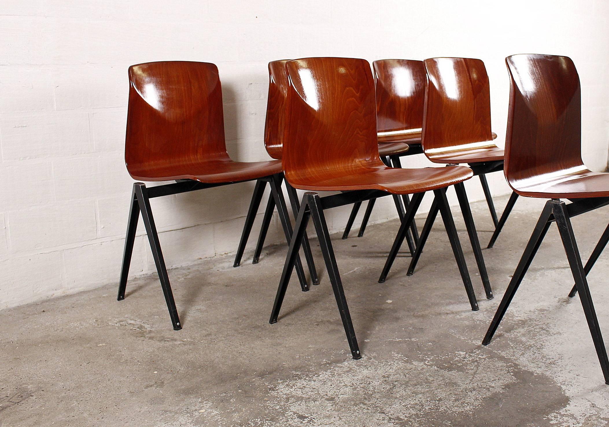 Set of six pagwood chairs with plywood seats veneered in rosewood. The frame is made from black lacquered metal.