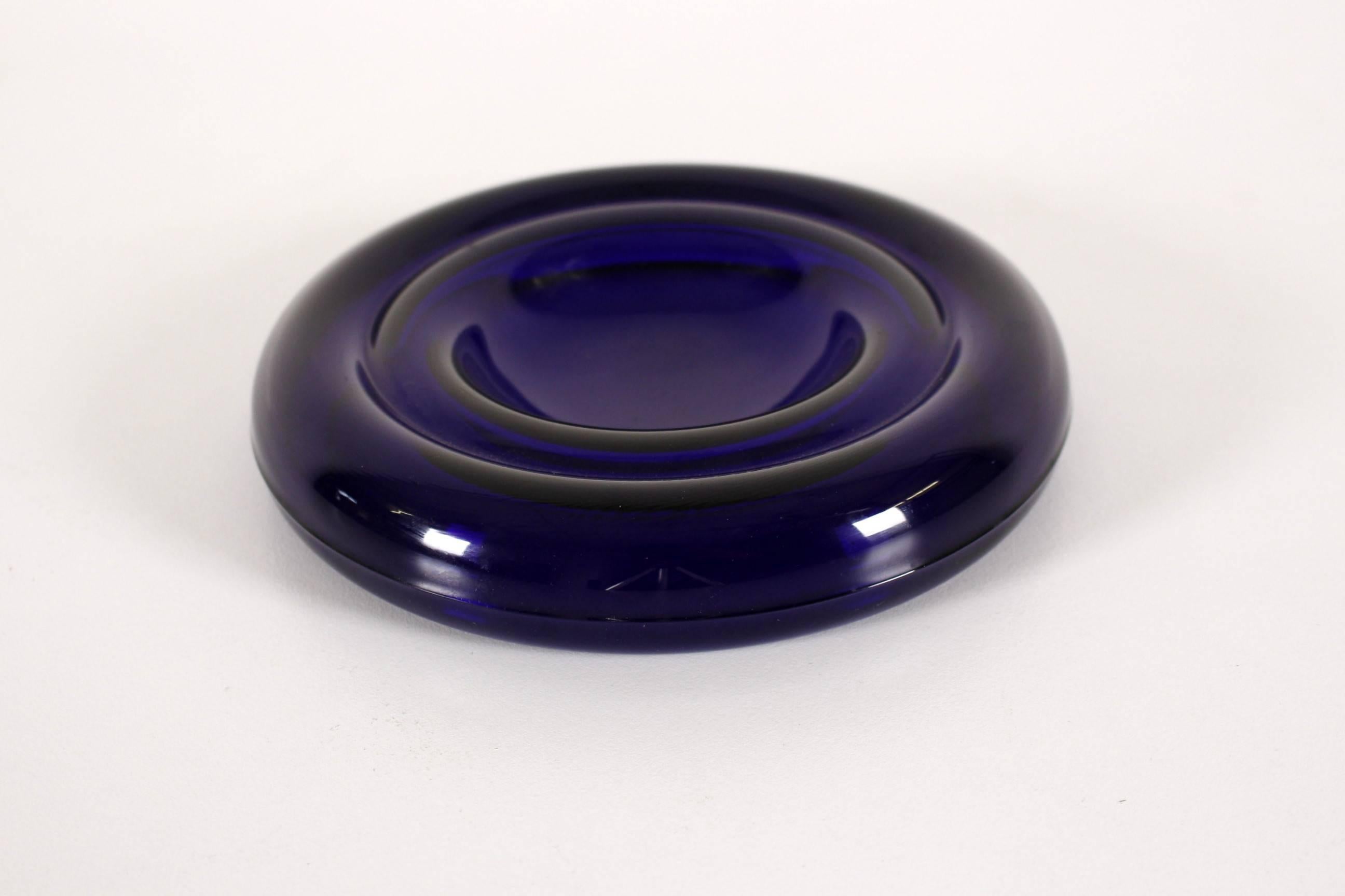 Ashtray by the designer Enzo Mari was created during the 1980s and is made from dark blue glass.