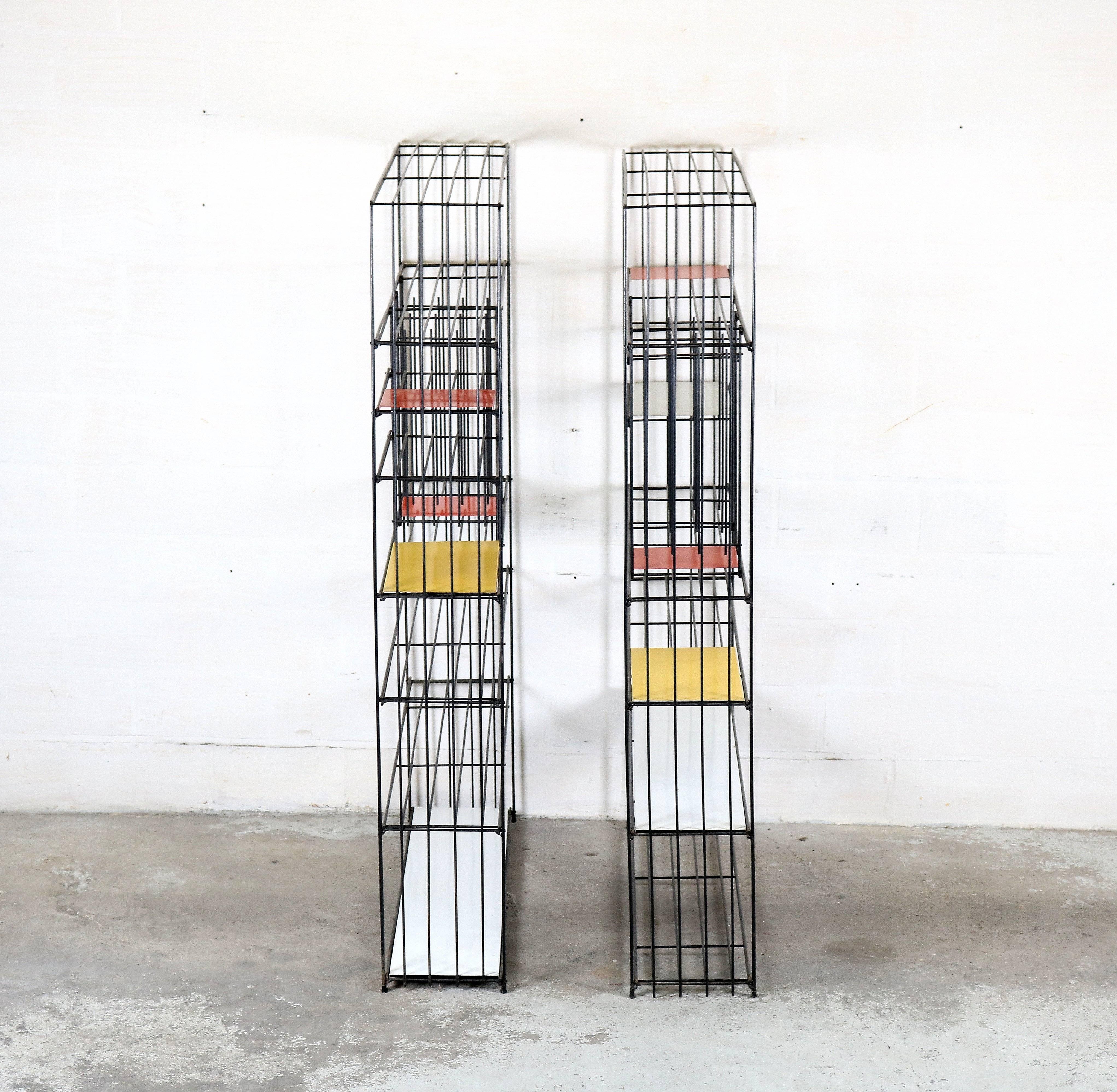 This bookcase or room divider was designed by Tjerk Reijenga for Pilastro. Is made from black steel and colored metal shelves (white, red, yellow).
