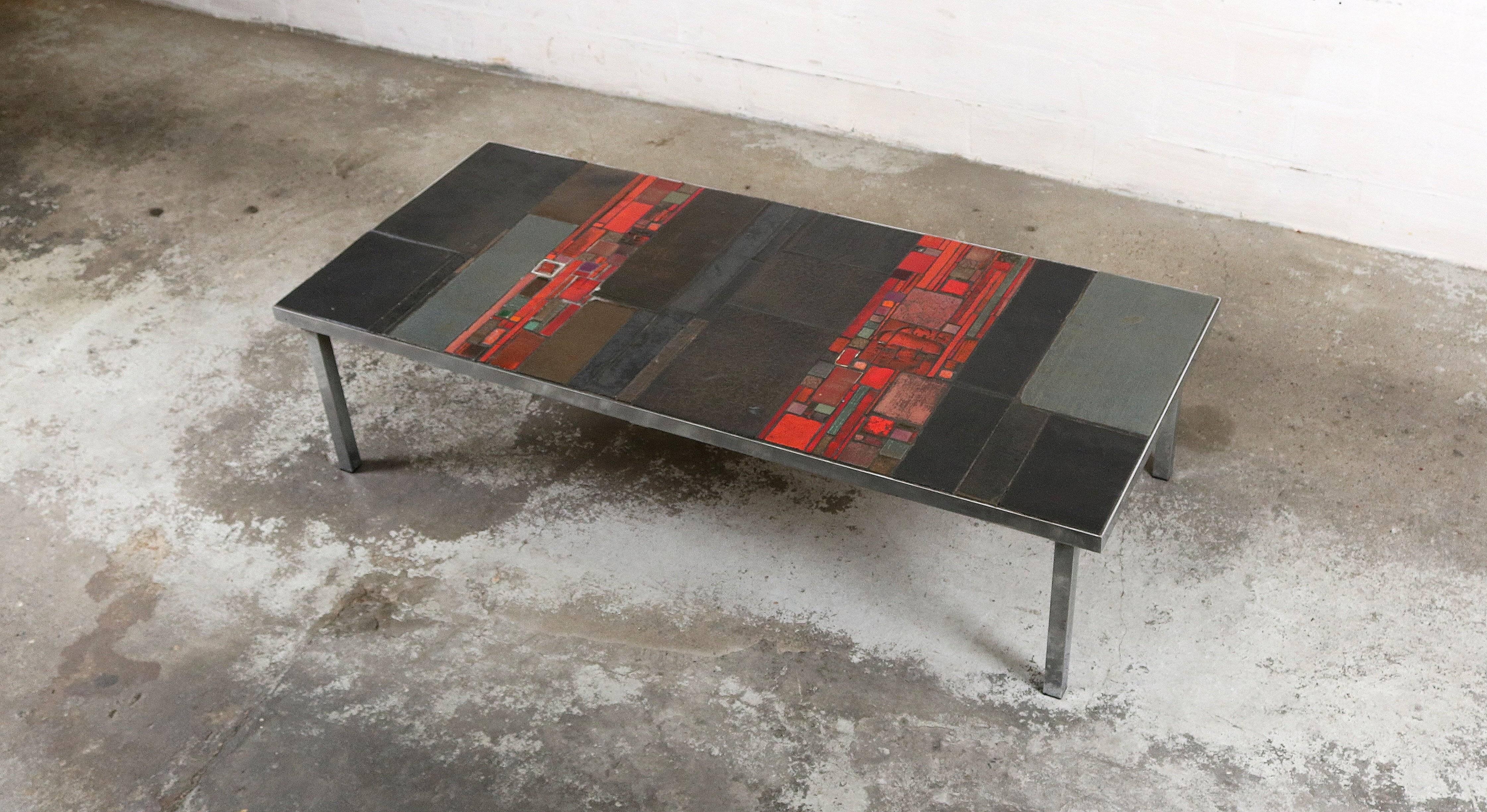 Coffee table designer and ceramic artist Pia Manu.
The table is made of black ceramic tiles and red mosaic pieces.
Has a sleek chrome base.