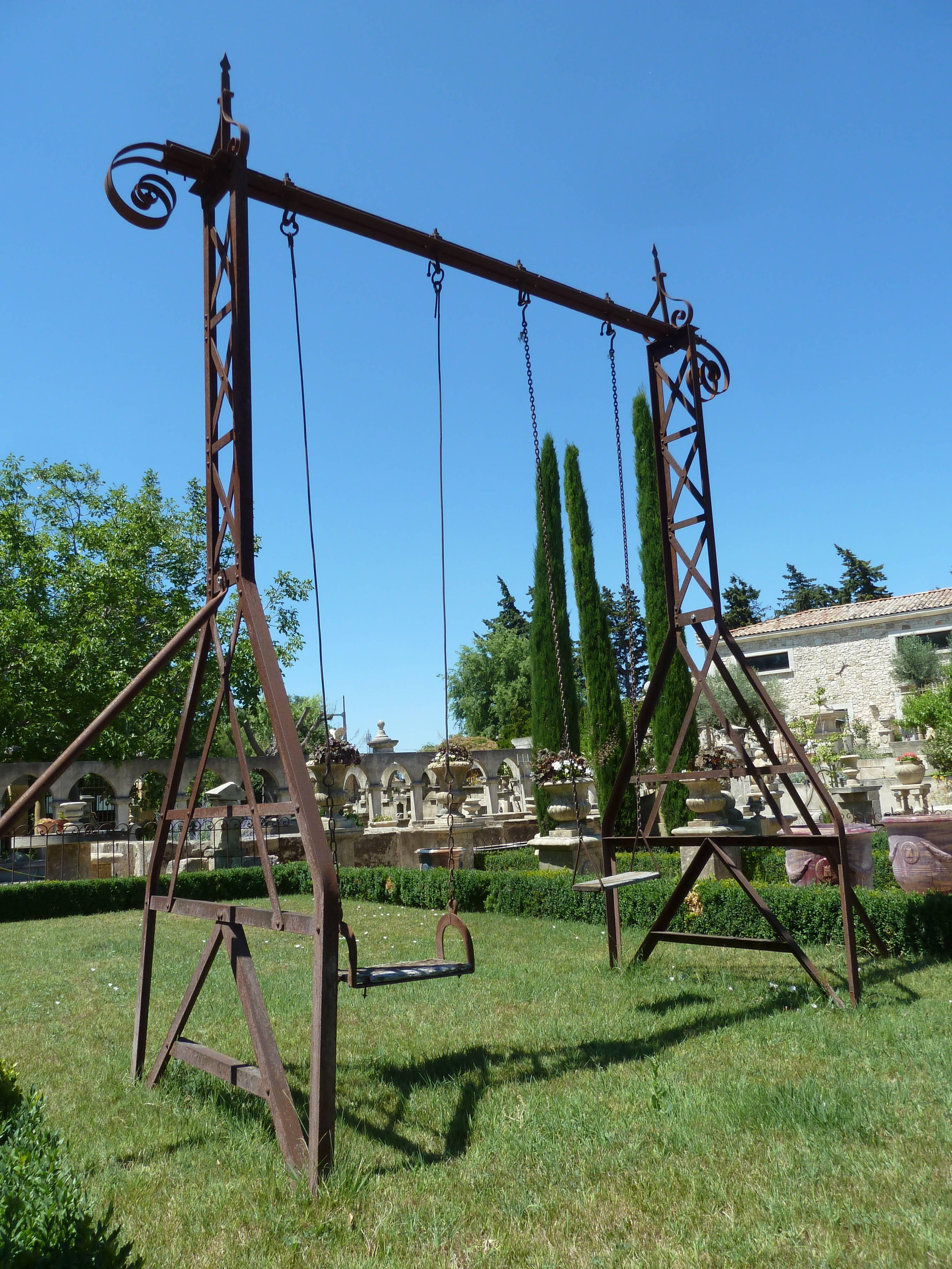 This wonderful French wrought iron swing dates from the beginning of the 20th century and has been made by a master craftsman from Gustave Eiffel's school.

Both wooden seats measures 50cm and 40cm long.

This is an essential decorative item for