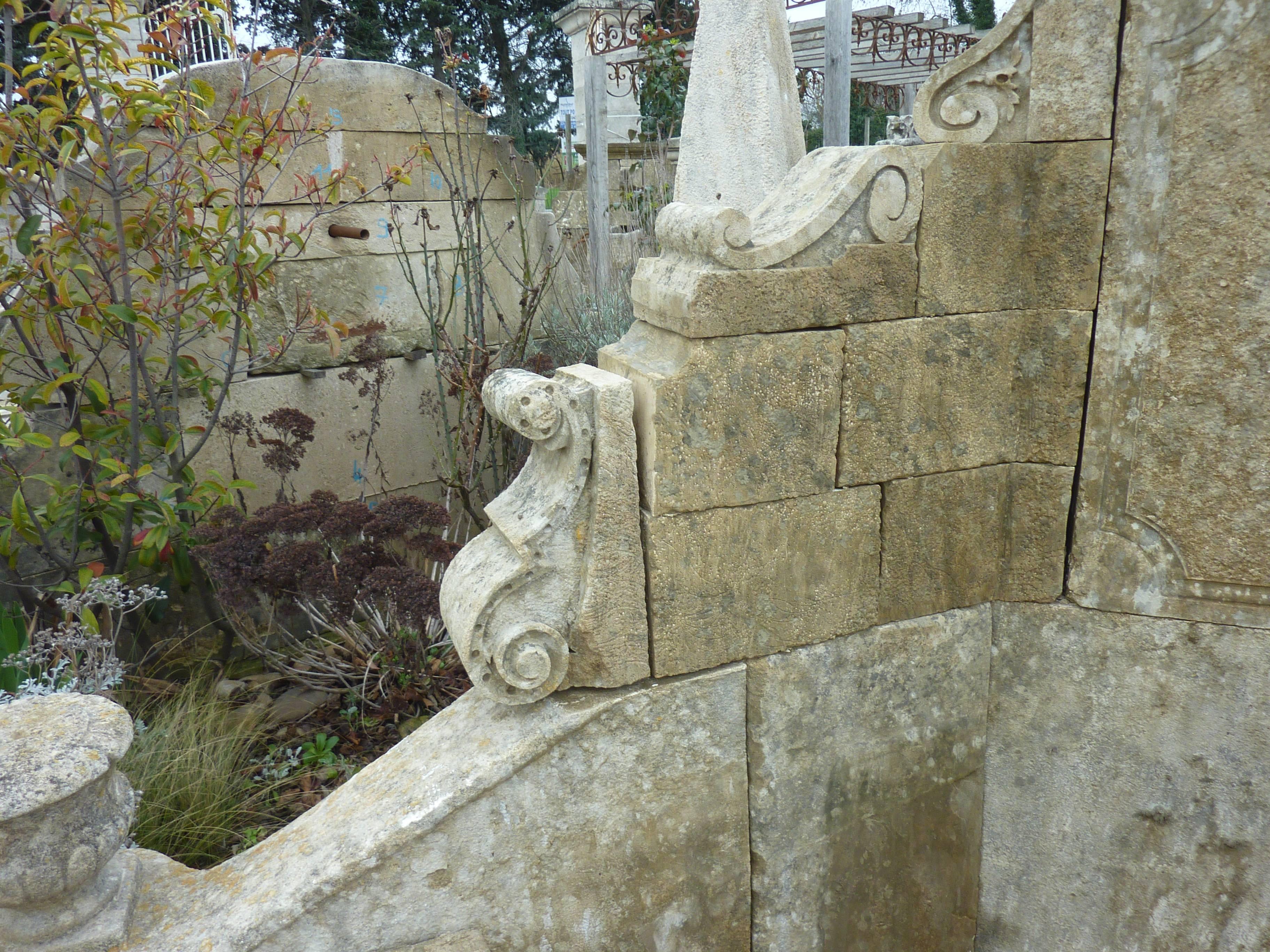 Hand-Carved Unique Wall-Fountain Carved in French Limestone with Curved Basin and Sculptures