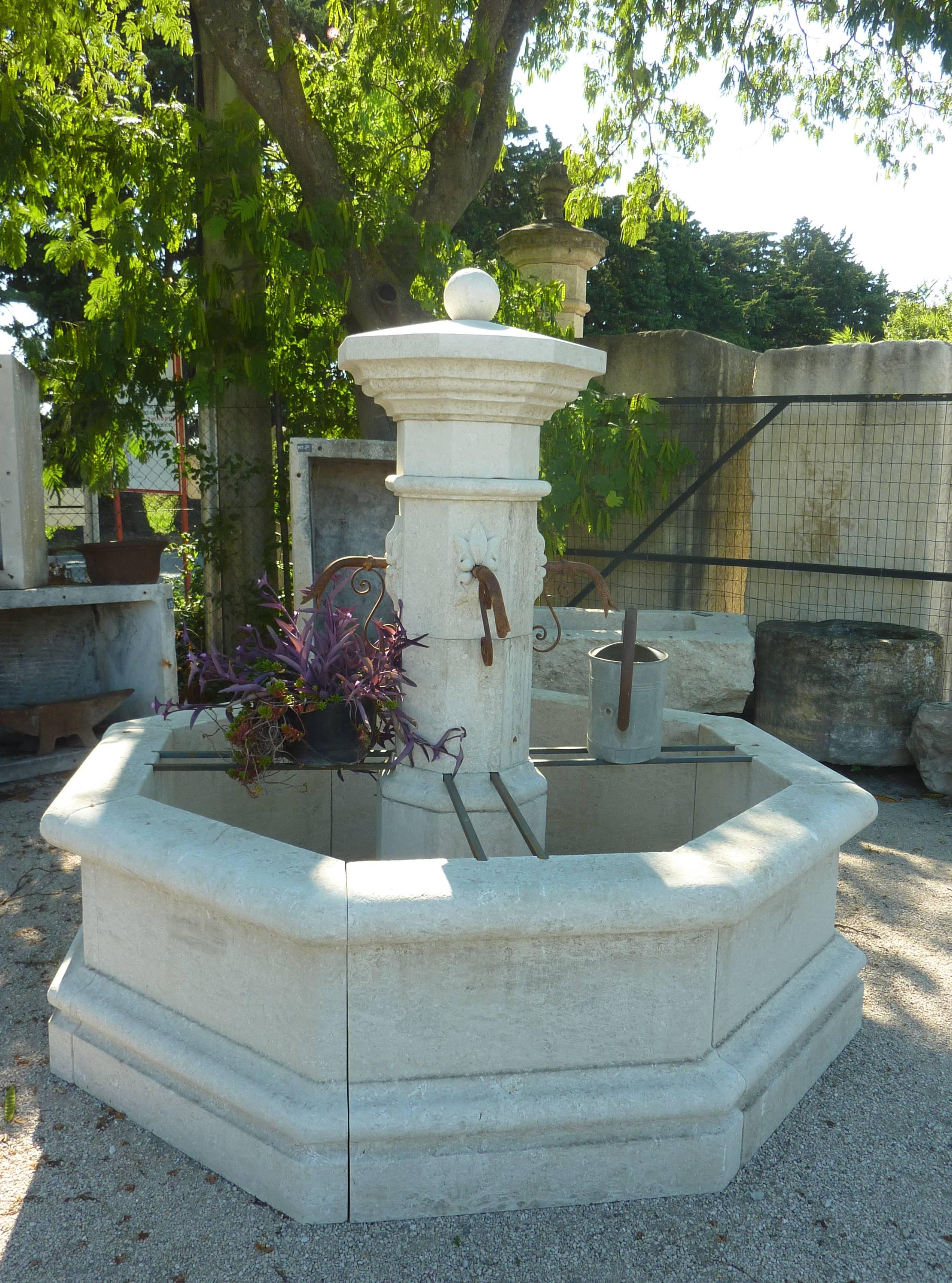 This octagonal fountain, a beautiful village fountain, is carved by hand in our workshops in a natural French limestone.

Composed of a large surrounding base, a high moulded basin topped by large copings, a central shaft and a fine capital ending