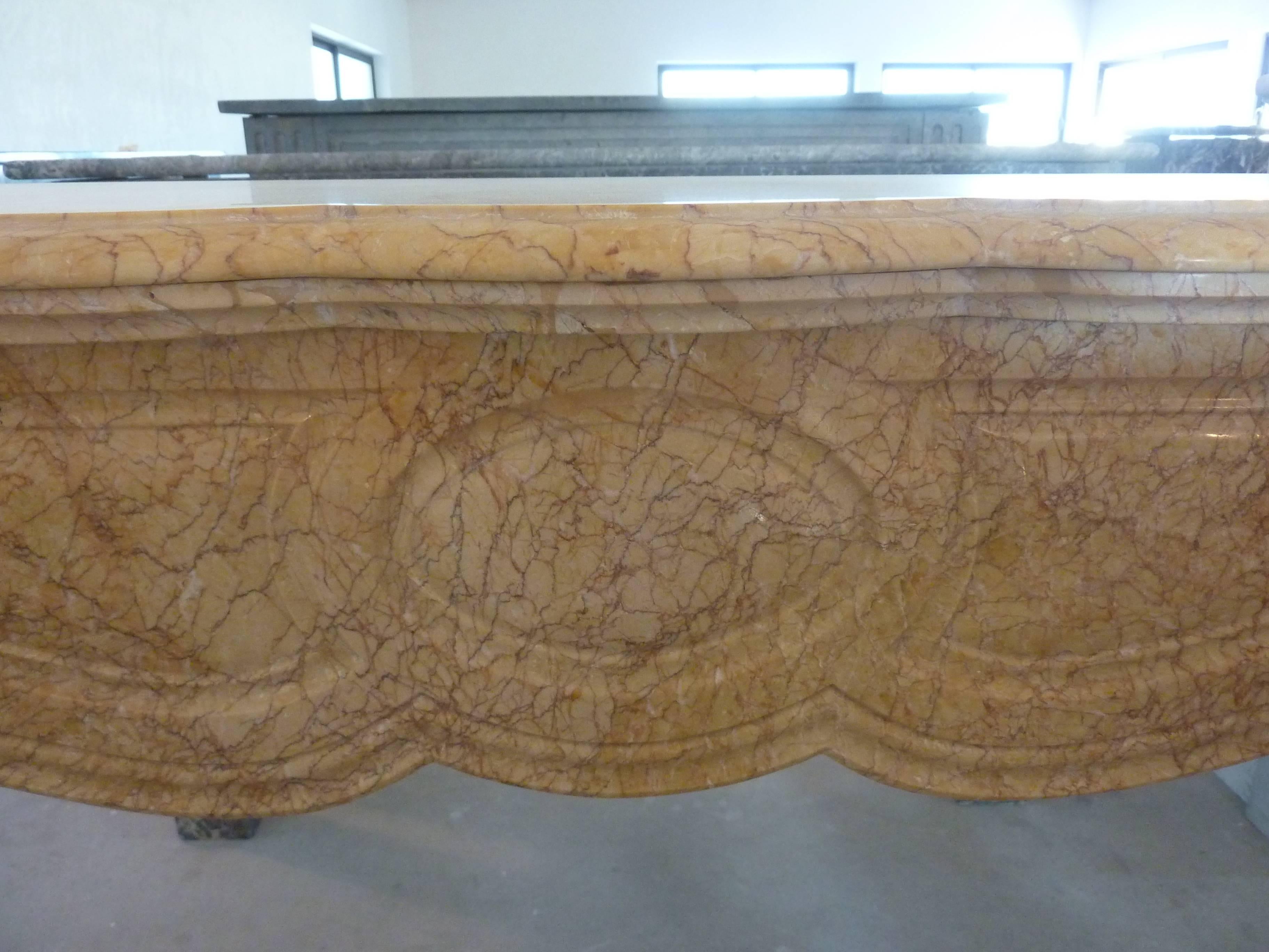 This wonderful antique fireplace is made of Trets marble. This marble was extracted from quarries that no longer exist. This Breccia marble has a light ocher color with thin red and brown veins.

This 19th century Pompadour fireplace is strongly