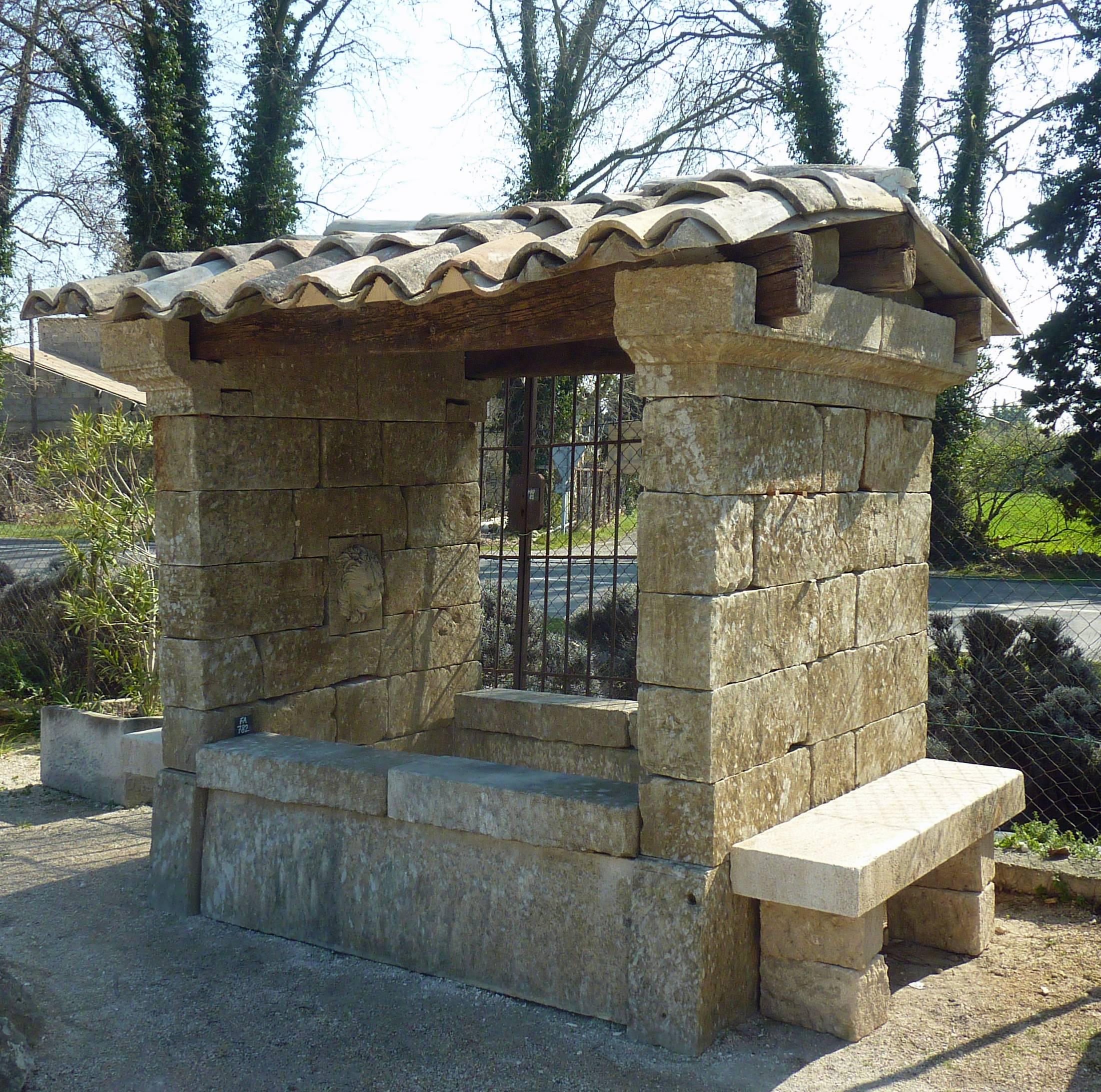 This 19th century stone shelter fountain is a unique piece crafted with the greatess care with authentic reclaimed architectural elements. It also has accosted on both side a small stone bench. The roof is composed of ancient wooden beams and