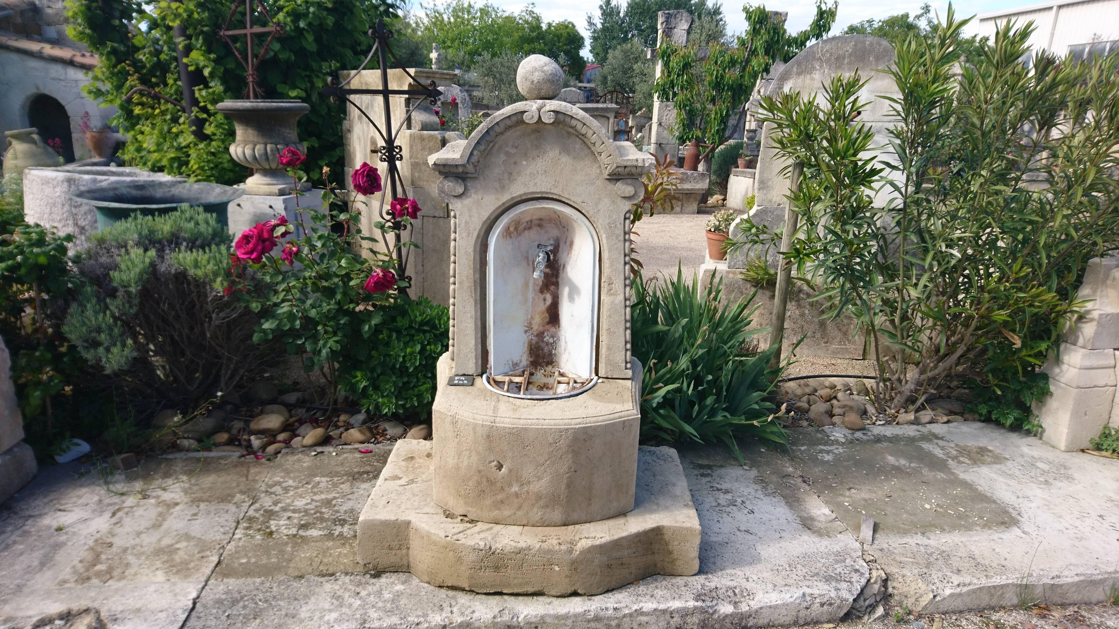 Charming little garden water fountain entirely composed of authentic antique materials !

This wall-mounted water fountain presents a thick rounded stone base, a solid monolithic circular basin, an elegant sculpted stone pediment, a curved cornice