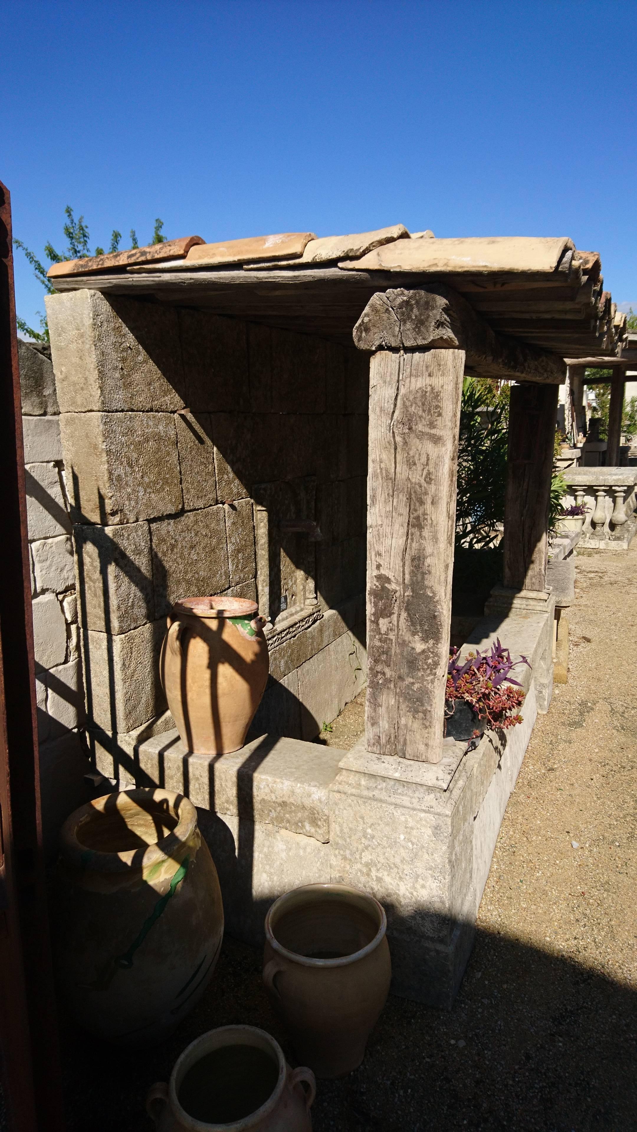 French Large Wall-Fountain with Stone Basin, Roof with Wooden Beams and Provence Tiles For Sale