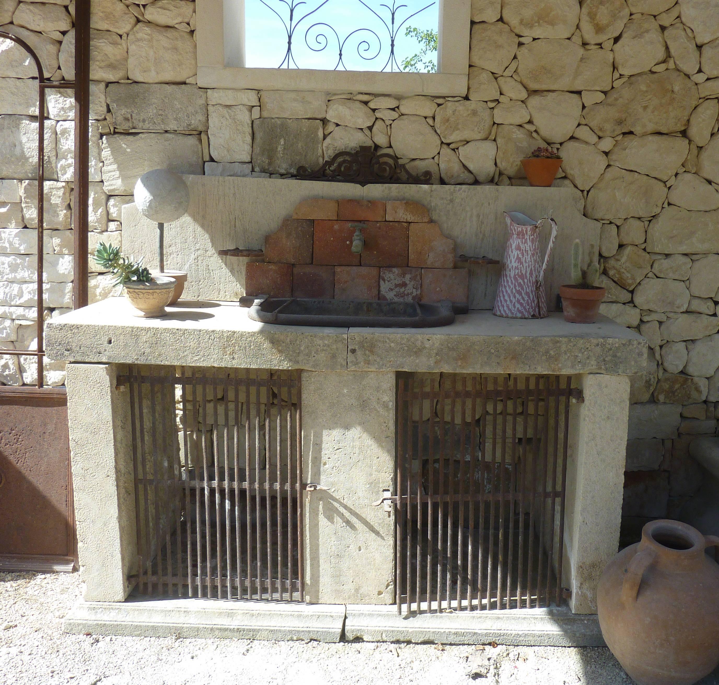 French Summer Kitchen in Antique Materials with Wrought-Iron Sink and Terracotta Tiles