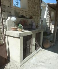 Summer Kitchen in Antique Materials with Wrought-Iron Sink and Terracotta Tiles