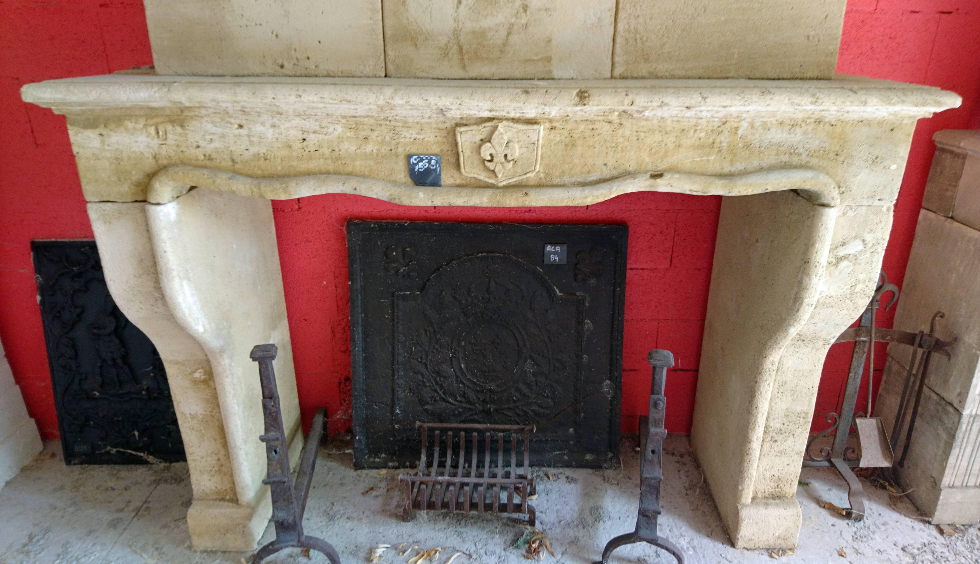 This Louis XV (18th Century) antique fireplace with trumeau was hand-carved into a natural limestone quarried in the South West of France. 
Its original simplicity makes it unique as well as its beautiful natural patina.

The stonework trumeau is