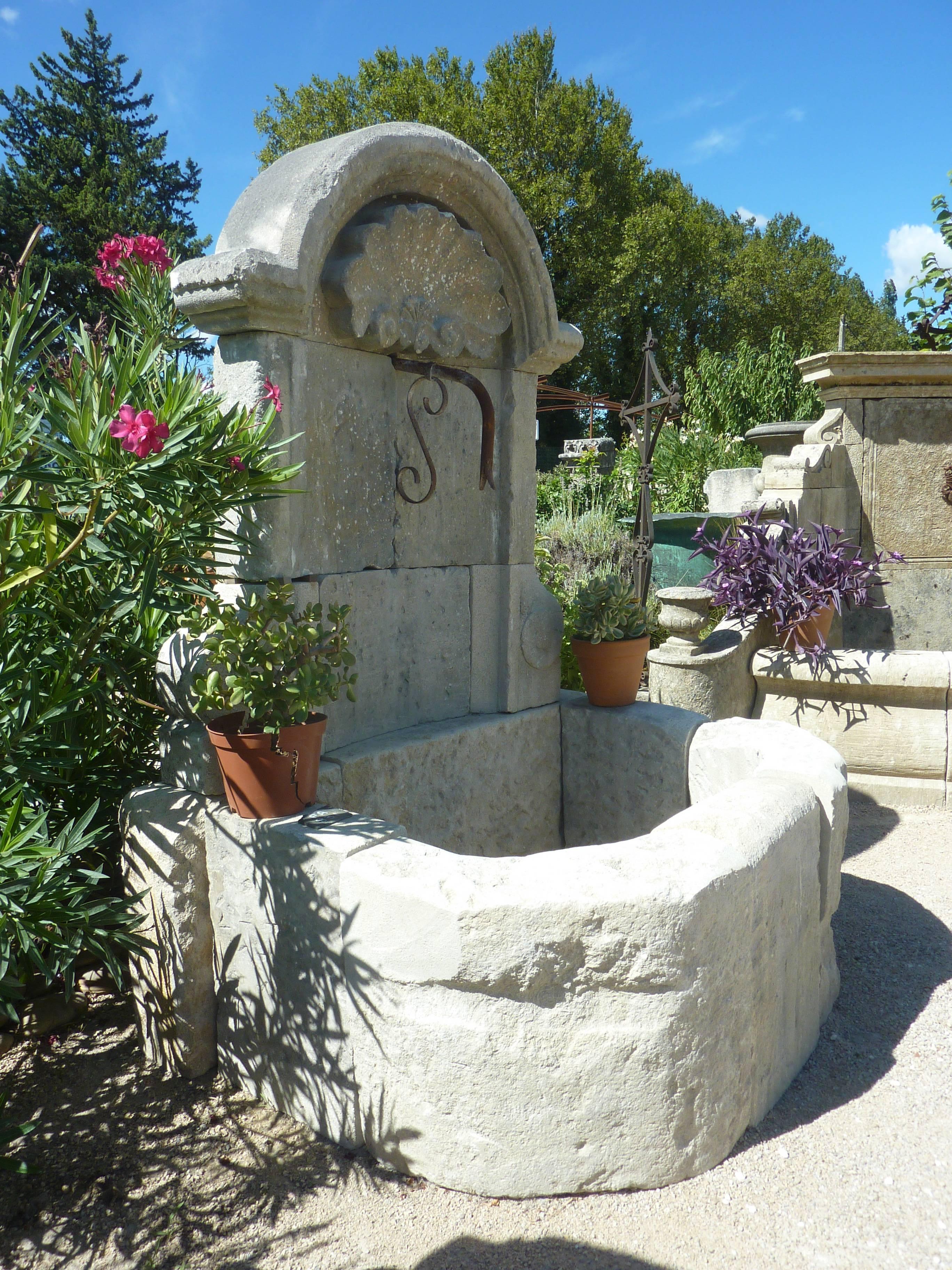 This beautiful stone fountain is a unique piece that will delight your exterior and enhance your garden.

The sobriety of its semi-rounded basin contrasts with the sumptuousness of its pediment finely carved by hand.

The shallow basin consists
