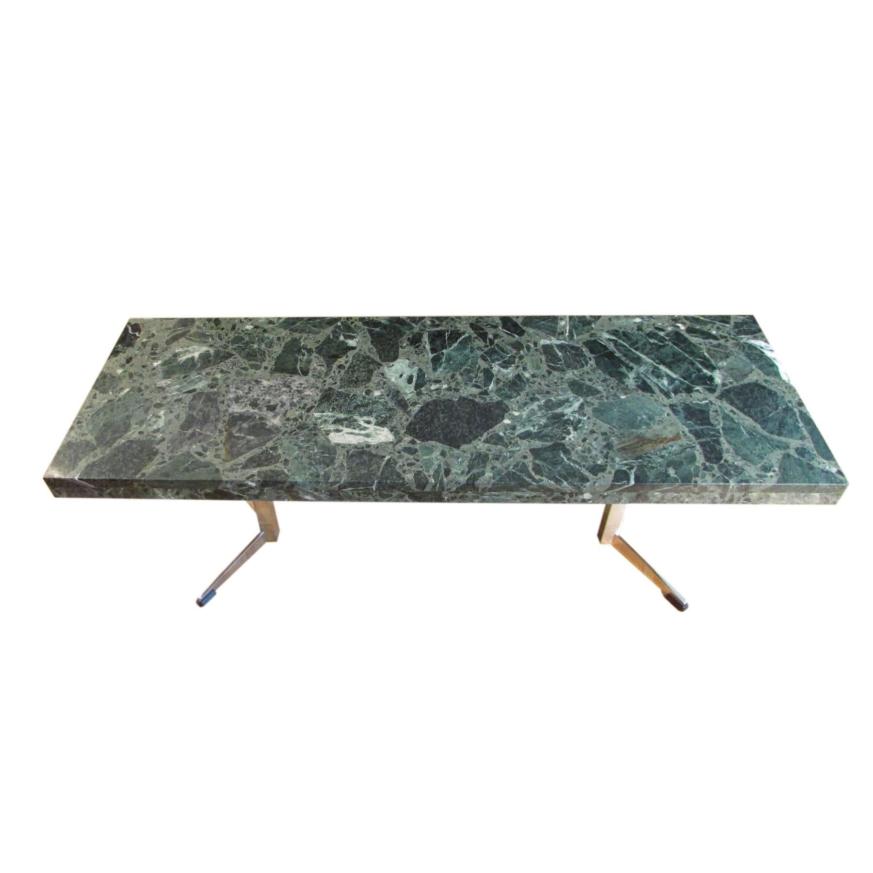 Nice coffee table with green marble top and chromed V-shaped feet.
The marble has a very nice design and the chromed feet help to give a 