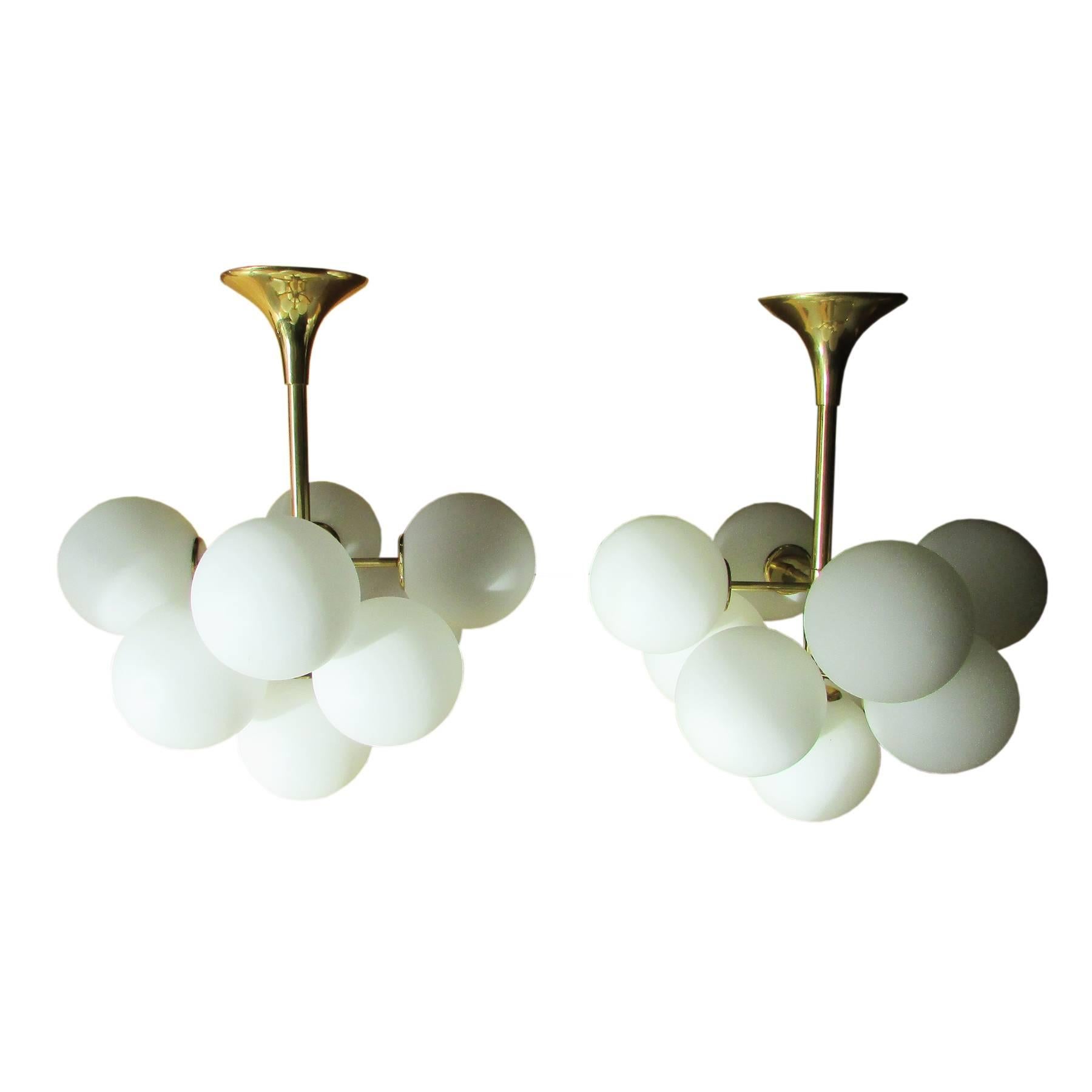 Set of two rare and high quality lamps designed by the Swiss artist and designer Max Bill.
Composed of nine opaline globes on golden structure each.
This special lamps have three lighting positions:
Four higher globes on, lower off
Five lower globes