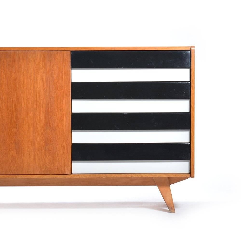 Elegant sideboard designed by Czech designer Jiri Jiroutek featuring Brusel 1958, type U-460. Two revolving doors and four drawers in black and off-white original colours. Fully restored in its original glory. The drawers have a wooden front and the