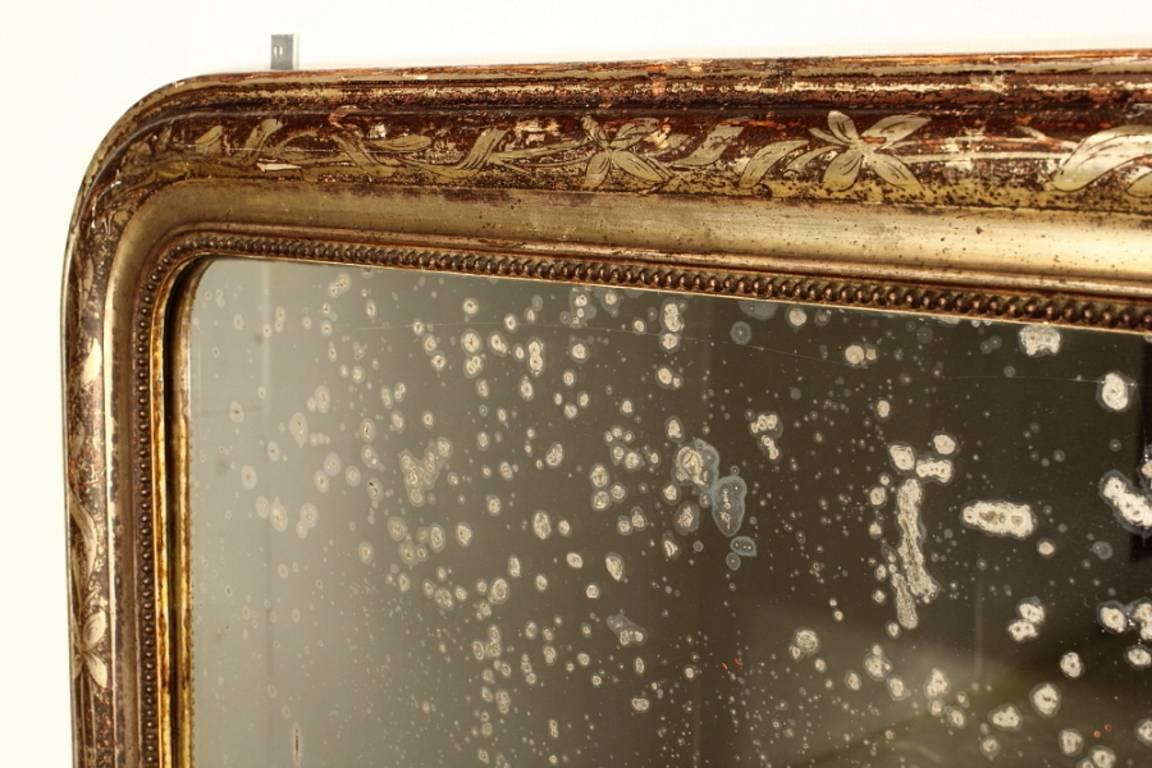 French 19th century over mantel mirror with beautiful aged gilding.

 