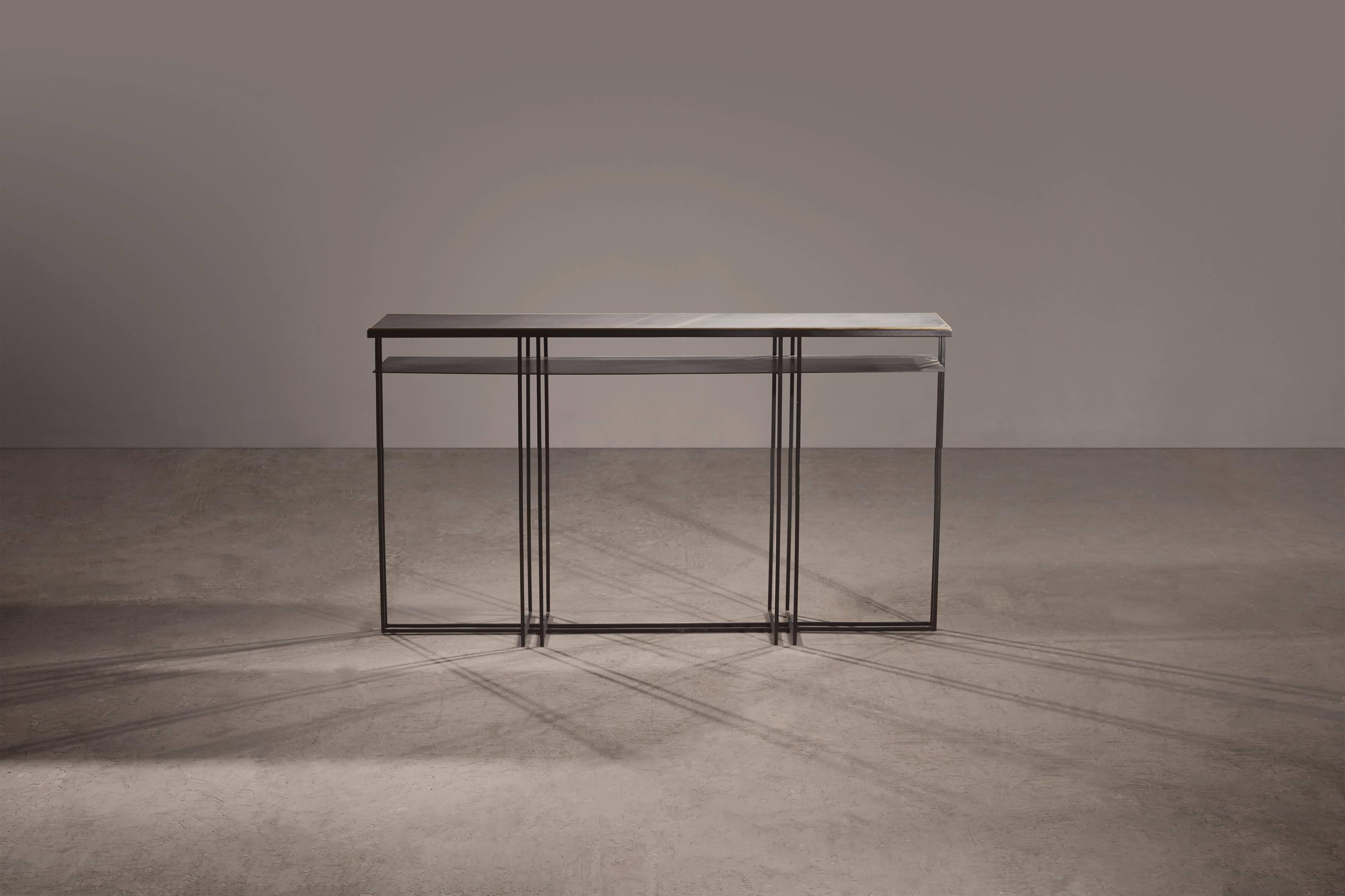 A console table in blackened steel and honed Cumbrian slate, with a polished brass trim. Hand crafted to order in the North. Bespoke finishes and sizes are available.

Measures: 180cm (length) x 35cm (width) x 80cm (height). 
Custom sizes