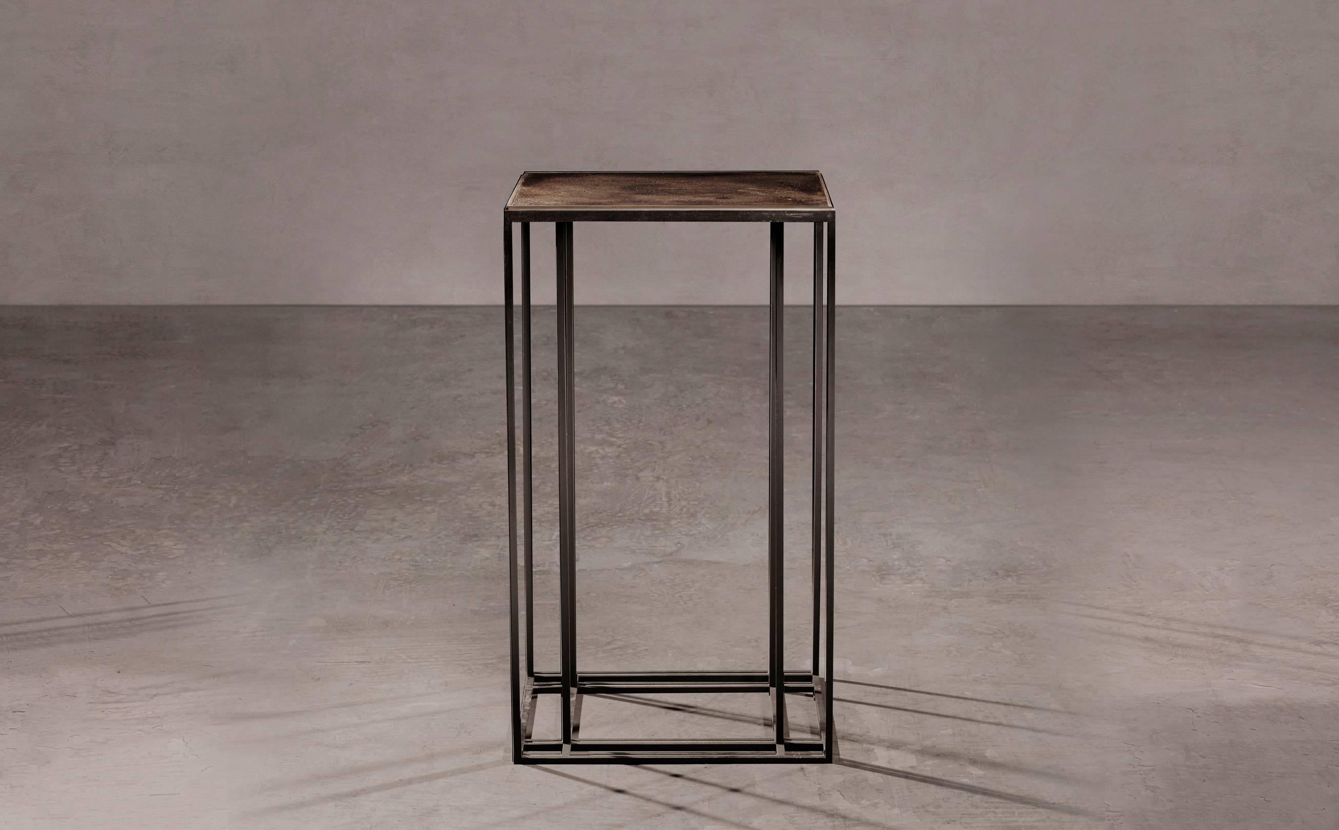 A display table in blackened steel and patinated brass, with a polished brass trim. Hand crafted in the North to order. Custom sizes and finishes are available.

Measures: 70cm (height) x 40cm (width) x 40cm (depth).
Custom sizes available.

Made to