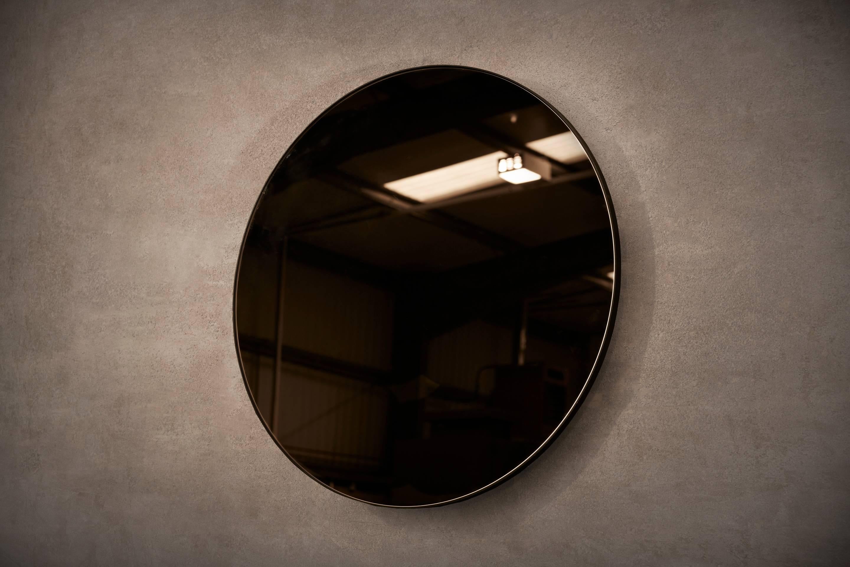 A minimal, circular wall mirror in blackened steel. Hand crafted in the North to order. Custom sizes and finishes are available. 

Supplied with two screw fixing points to rear face. Larger mirrors supplied with batten fixing.

Measures: 80cm
