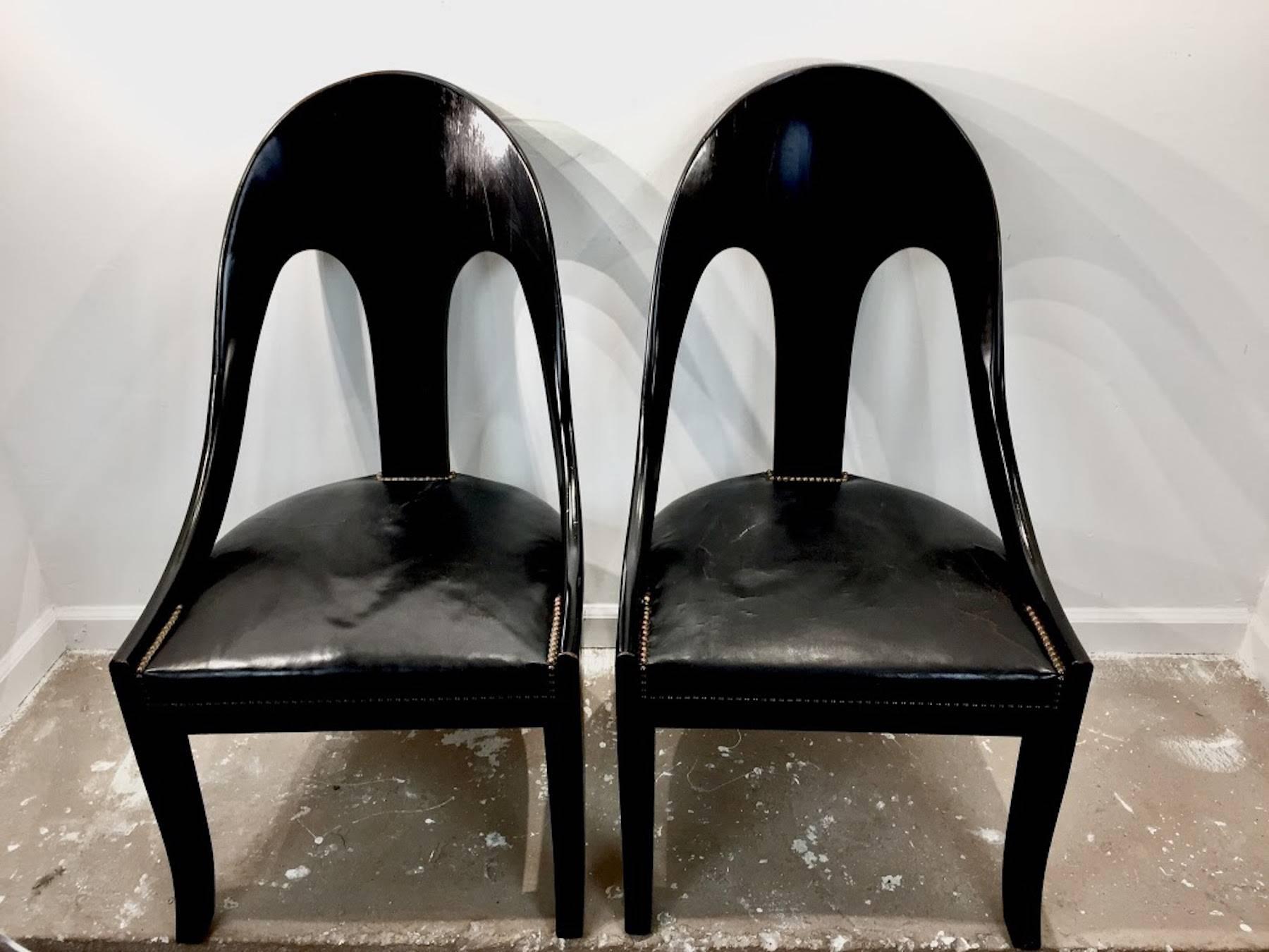 Pair of vintage black lacquer spoon back chairs, each one of typical form with original black leather and nailhead upholstered seats, 50% horse hair and 50% hog hair, sold by Miriam P. Sampson 171 West 57th Street NY, a contemporary of Dorothy