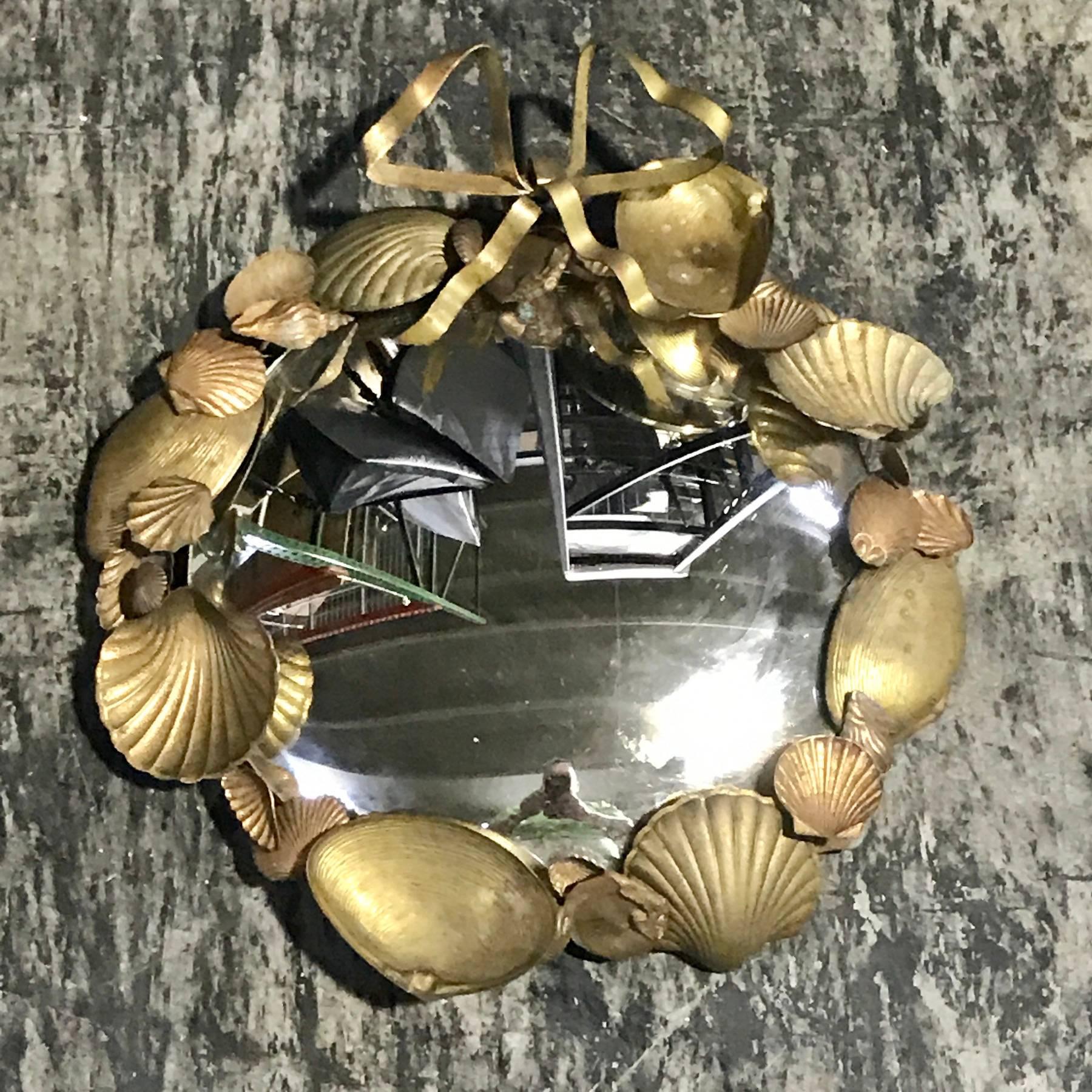 Pair of French brass shell motif convex mirrors, each one with a continuous surround of seashells, holding a 9.5 inch convex mirror, joined with a ribbon atop.
This item is at our Atlanta GA, Location, not Palm Beach.
